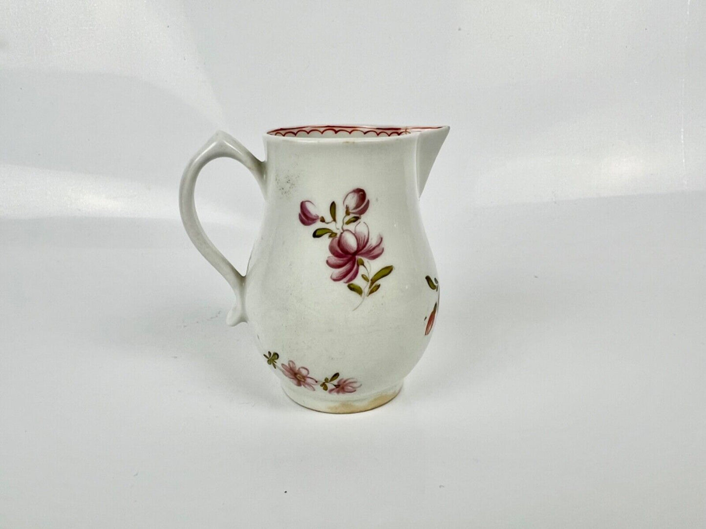 A Lowestoft 'Tulip Painter' creamer painted with floral sprays c.1775