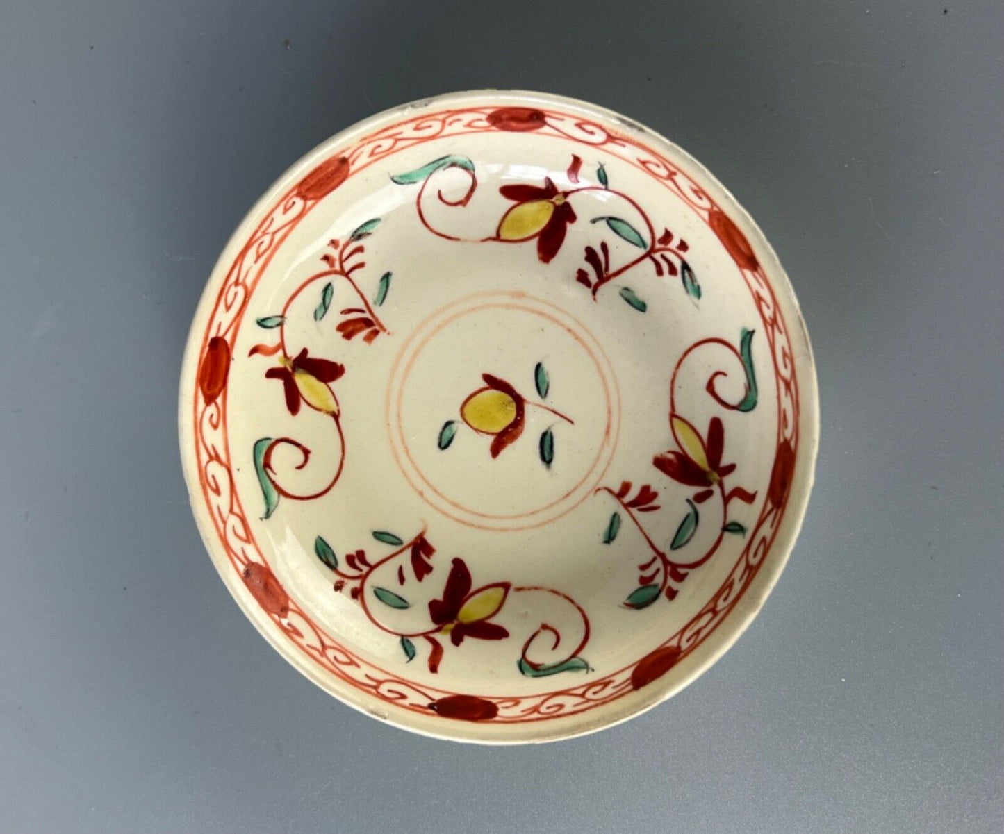 A rare and charming late 18thc miniature creamware hand painted saucer