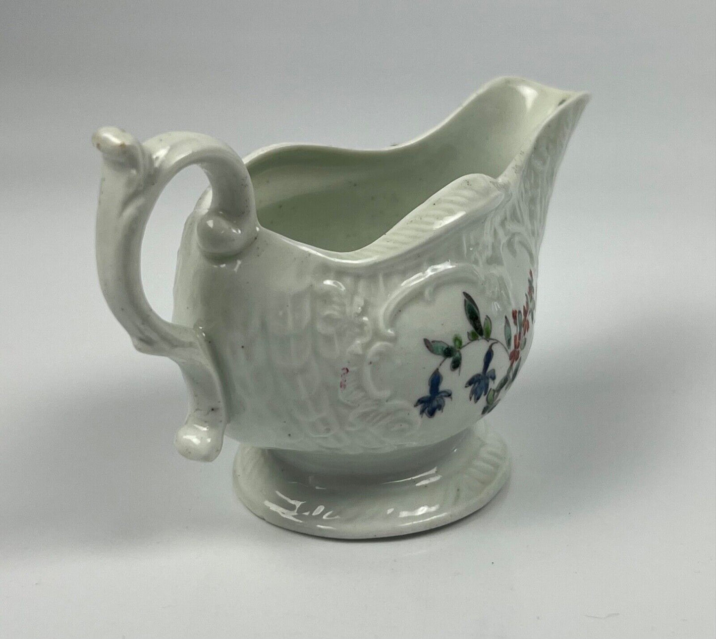 A Philip Christian Liverpool moulded polychrome porcelain sauceboat c.1770