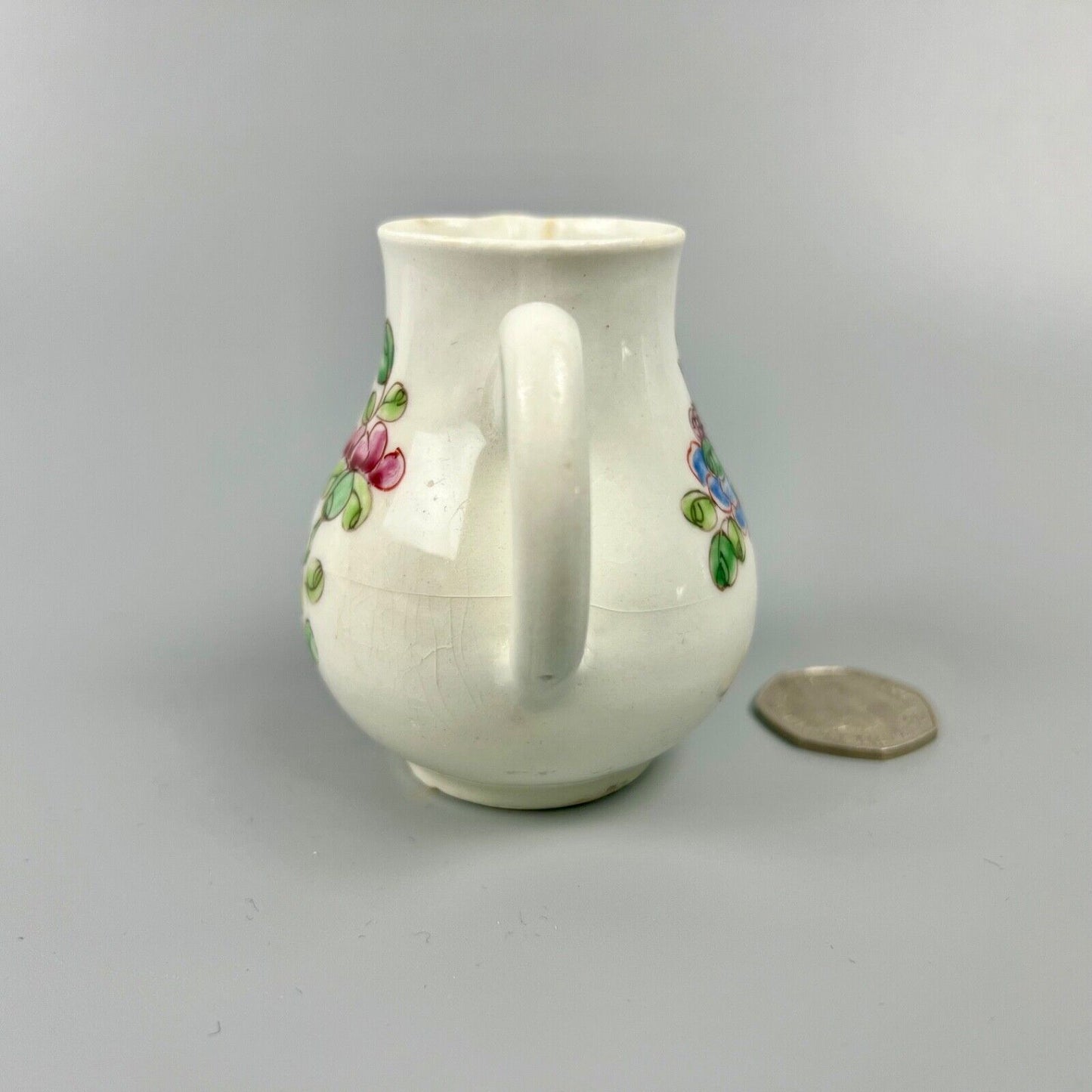 An early Bow creamer painted in famille rose style c1750-3