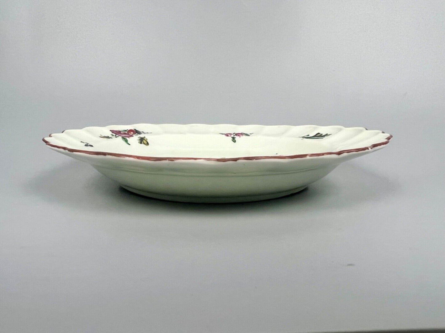 A 1st Period Worcester scalloped dessert plate painted with flowers c.1775