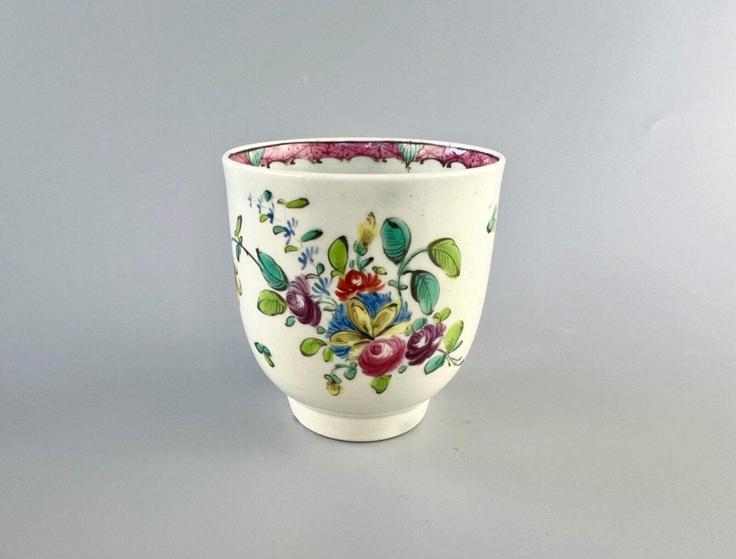A Worcester polychrome pattern coffee cup with unusual rim decoration c.1770