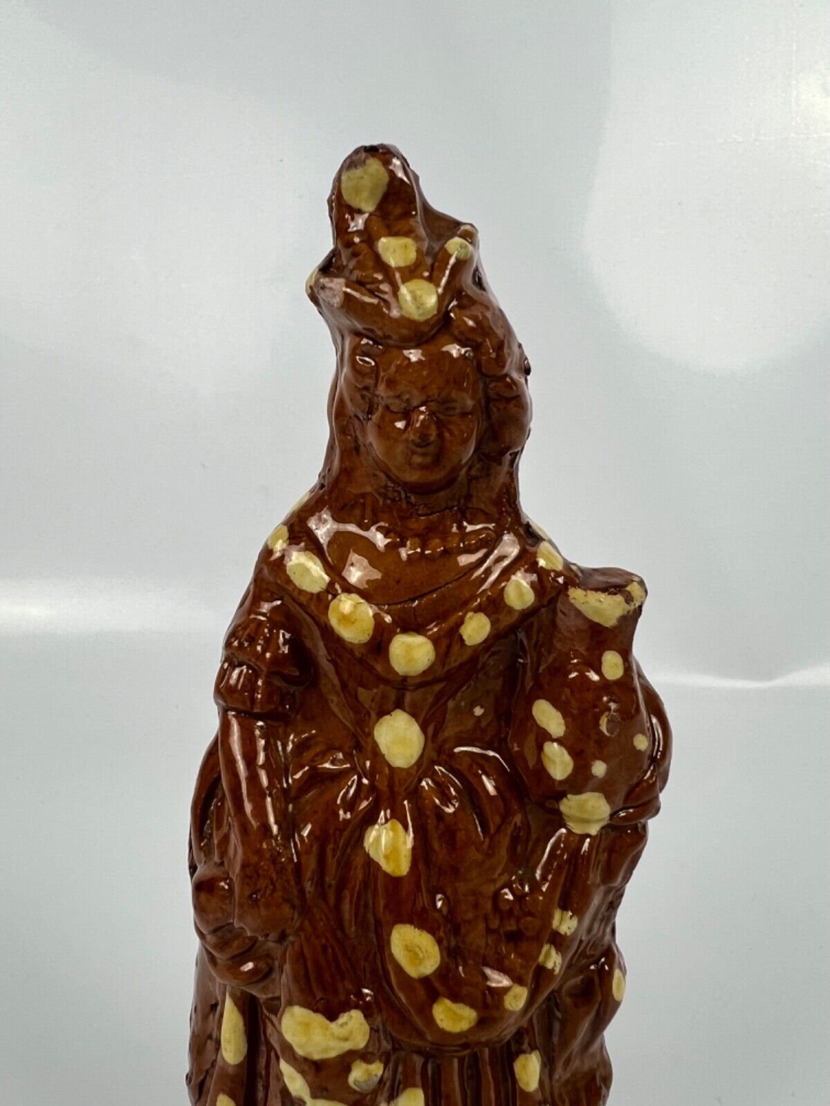 A cream dot decorated slipware figure of a woman on a treacle ground c1835