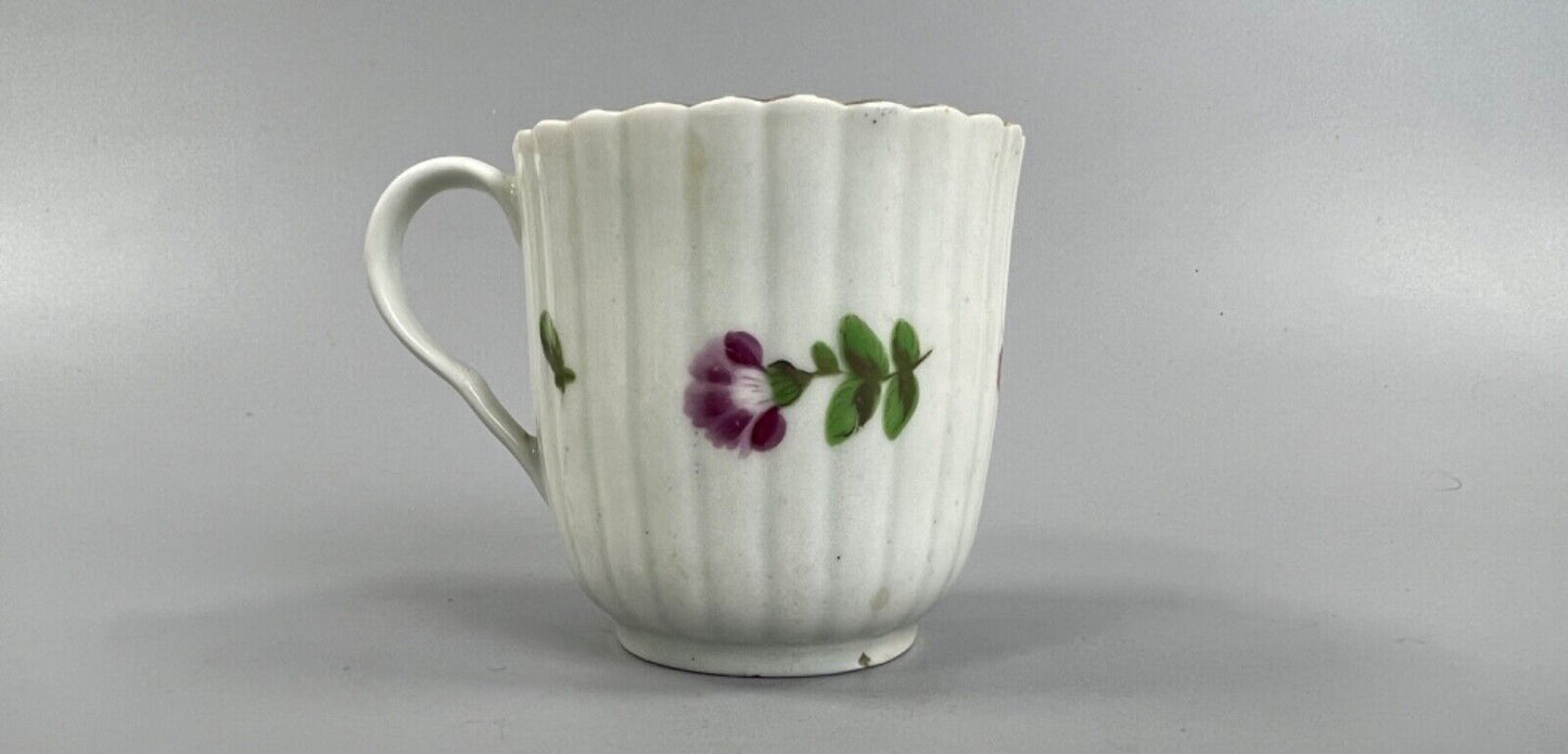 A Worcester reeded French shape coffee cup, painted with flowers and a ladybird