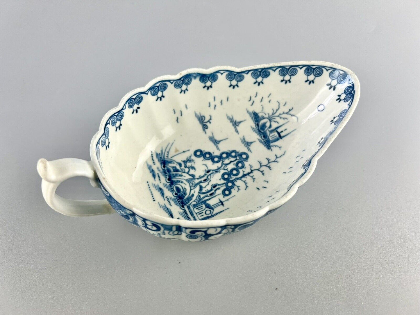 A Worcester First Period "Doughnut Tree" sauceboat. c.1777