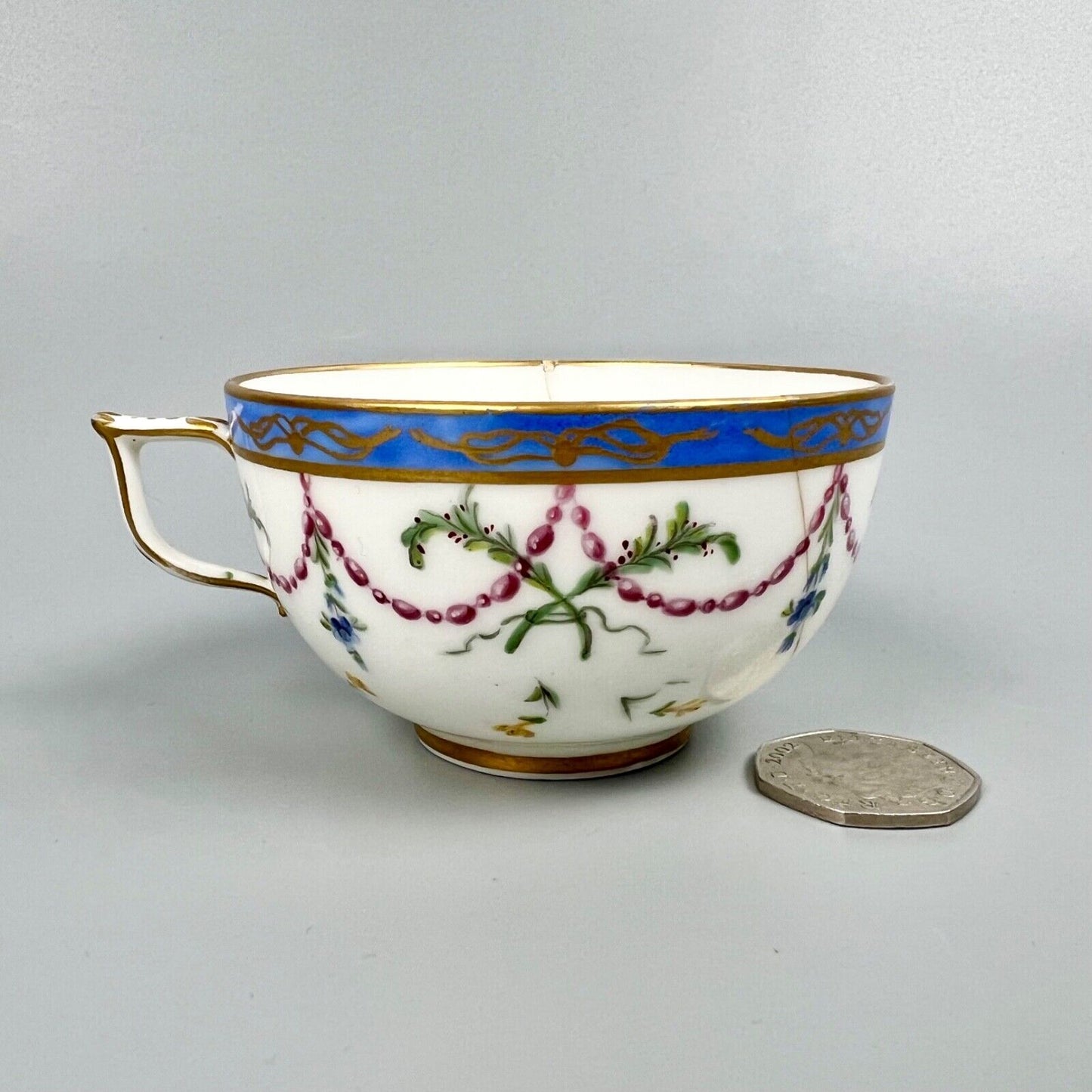 A Sèvres teacup painted by Mde Nouallhier. Date mark mm for 1789. Incised mark