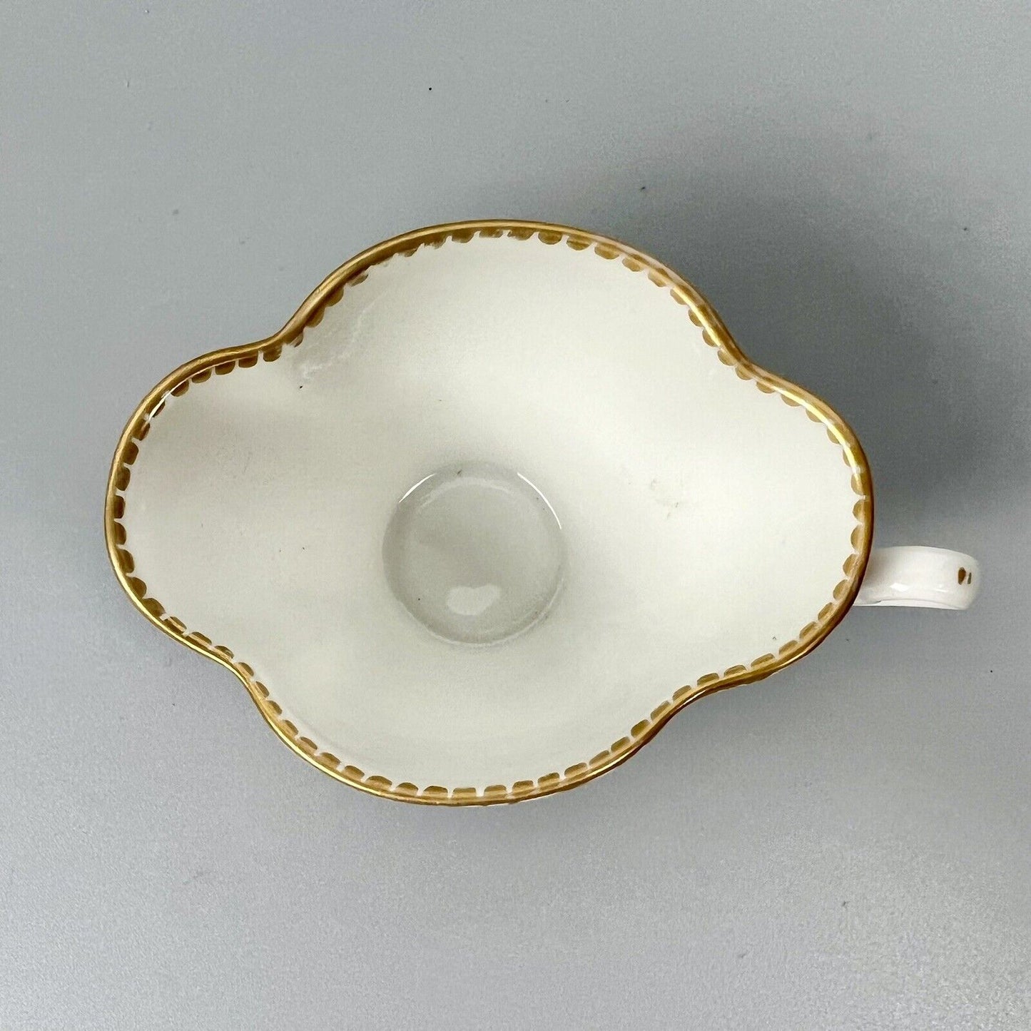 Dresden quatrefoil teacup & saucer painted with romantic scenes. 'AR' mark c1880