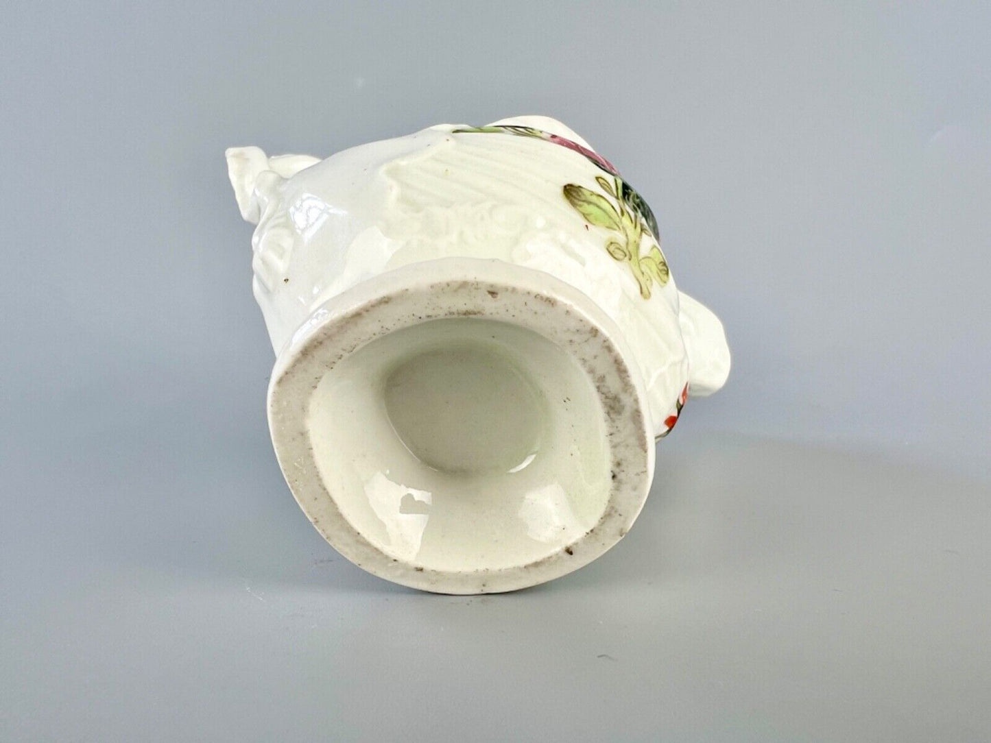A c.1765 Worcester lamprey-handled dolphin ewer cream jug painted with flowers.