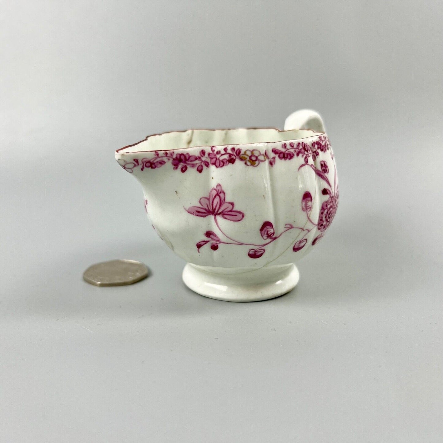 A rare early Derby peach-shaped creamer in 'Banded Hedge' pattern c.1765