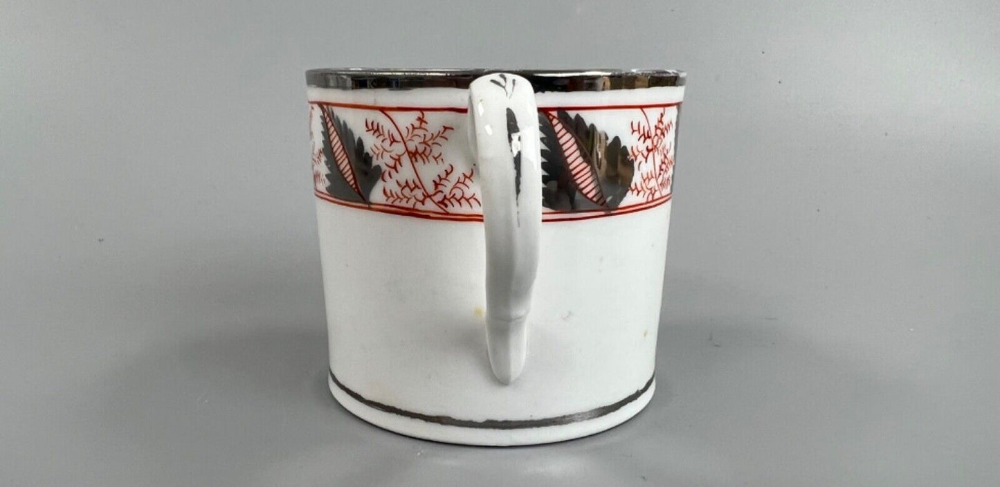 An early 19thc Coalport coffee can with silver lustre decoration.
