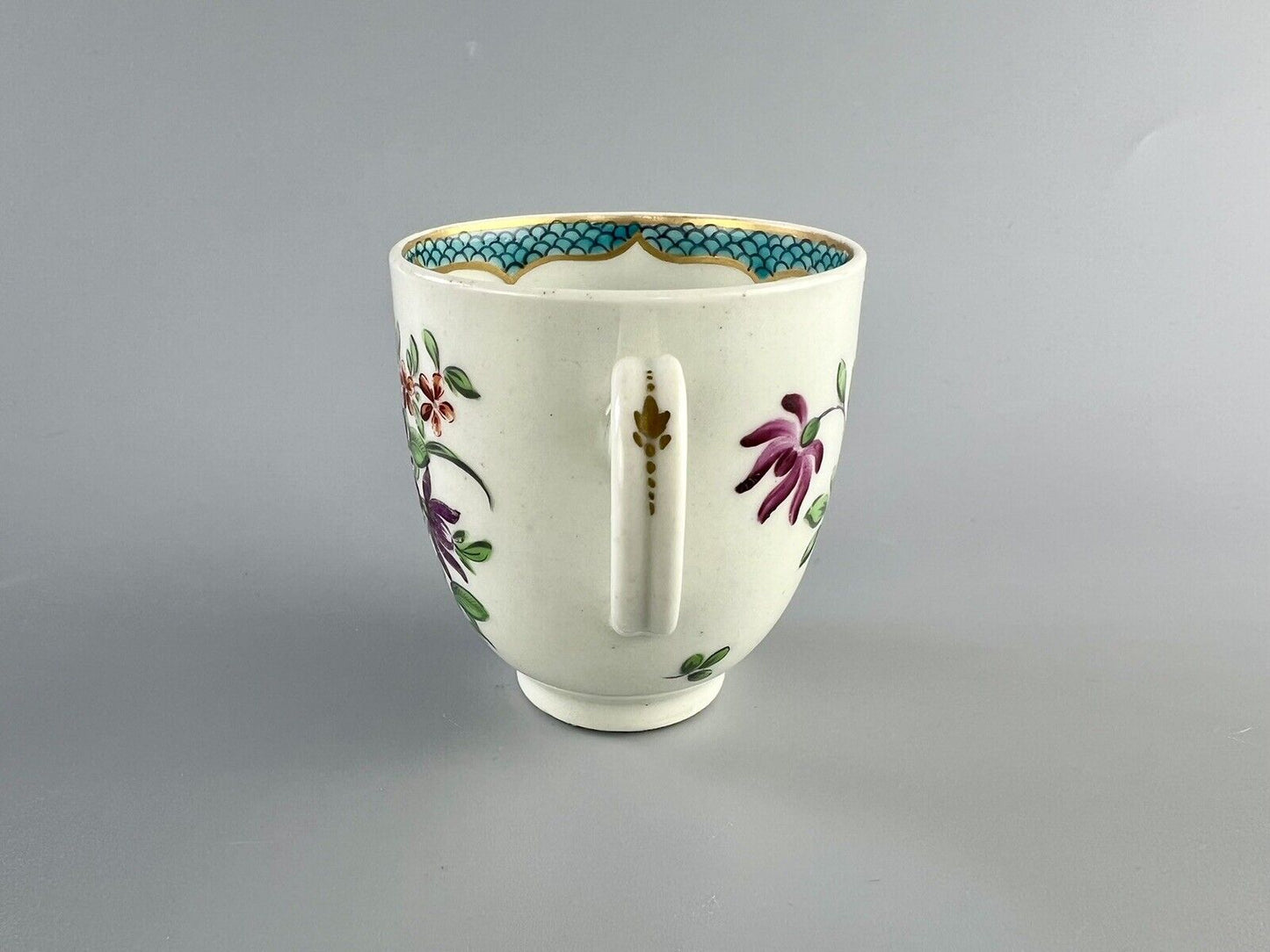 A 1st Period Worcester polychrome coffee cup c1770. Sprung handle.