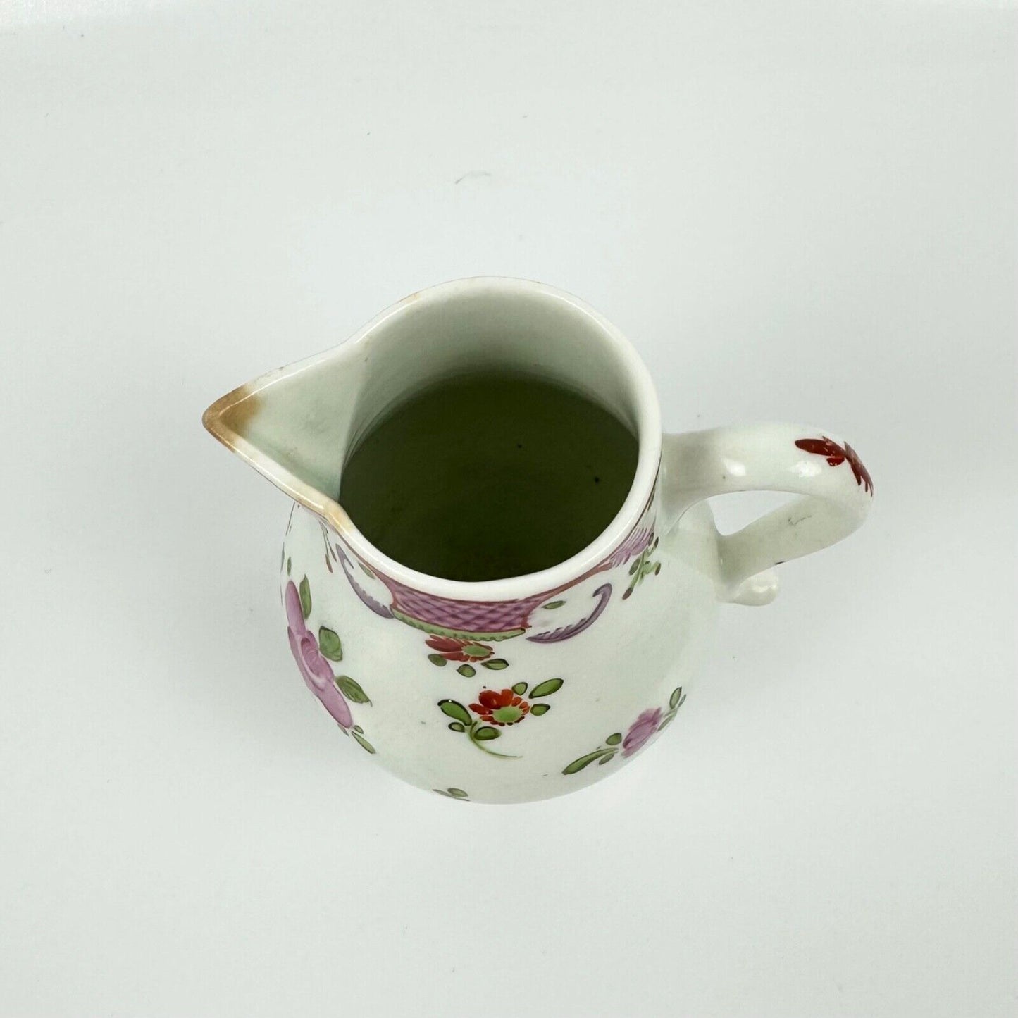A Lowestoft sparrowbeak creamer c1775 painted with a Curtis style pattern