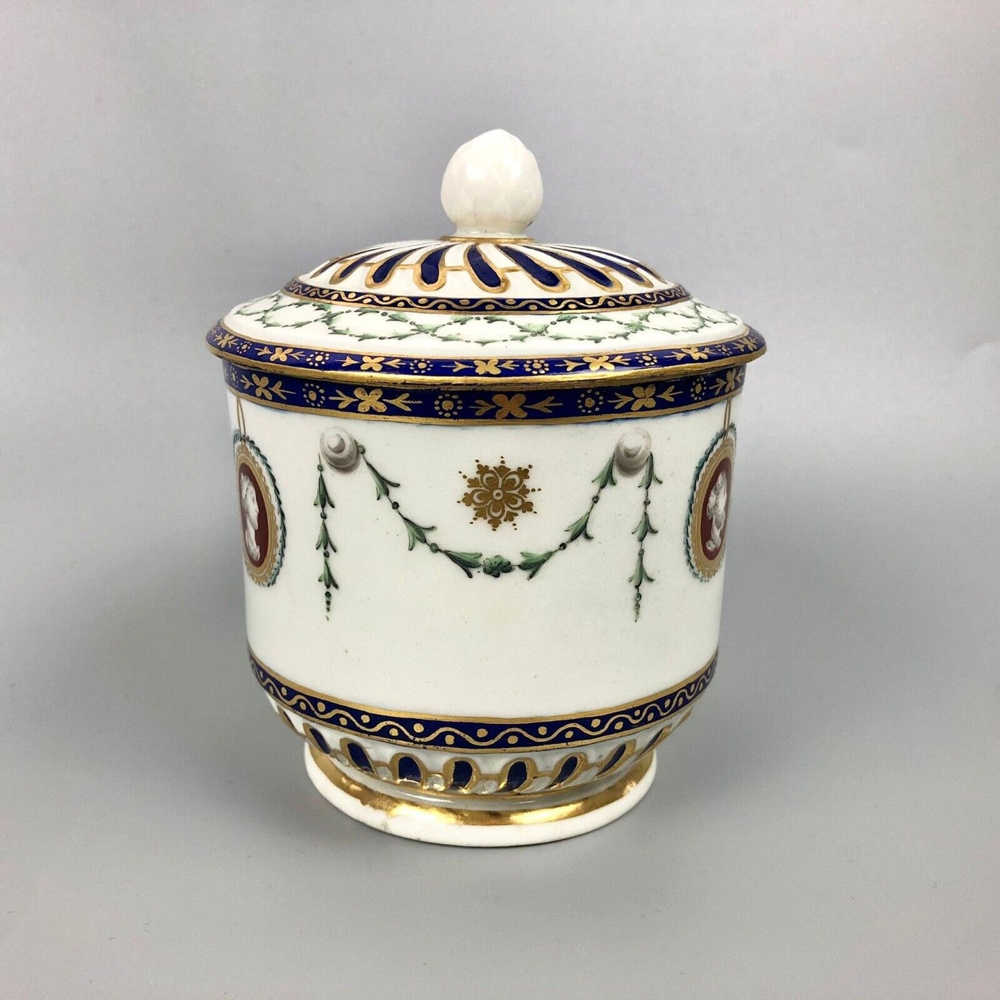 A rare Chelsea-Derby empire-shaped sucrier with classical masks. c.1770