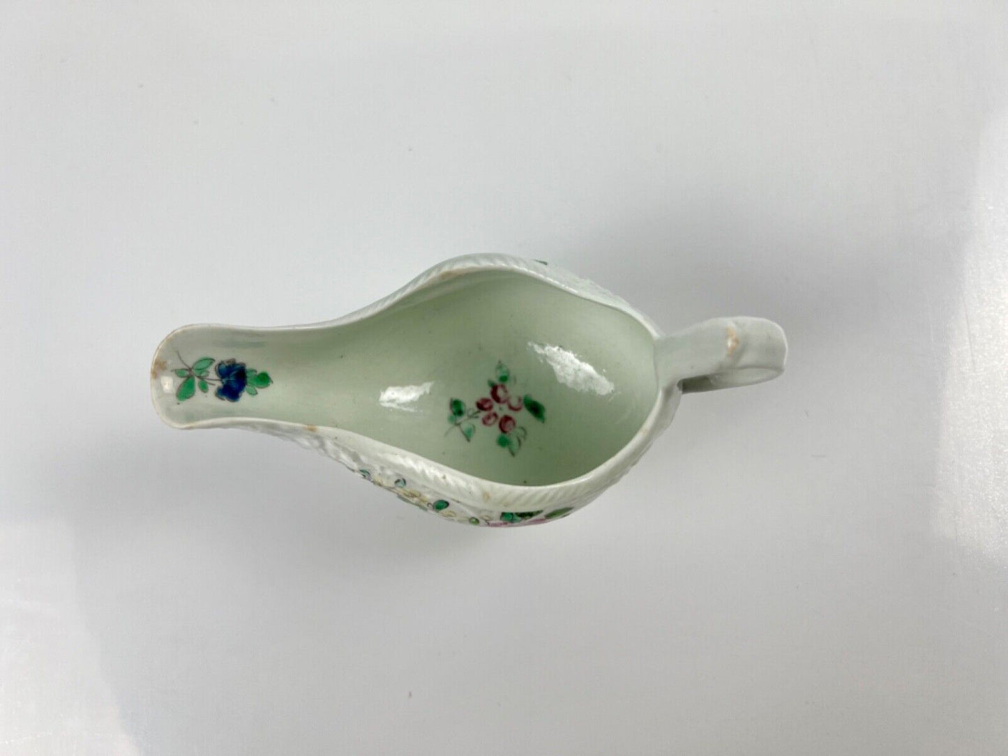 A Philip Christian Liverpool moulded polychrome porcelain sauceboat c.1770