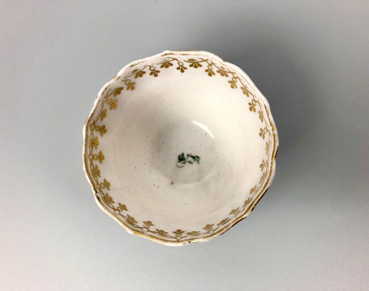 A Derby tea bowl and saucer in the style of Bristol c.1775