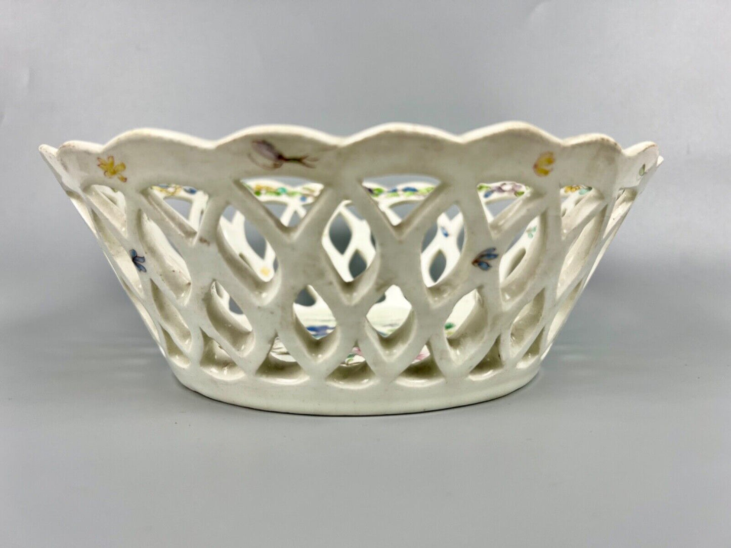A pair of large Bow porcelain famille rose reticulated baskets c.1752