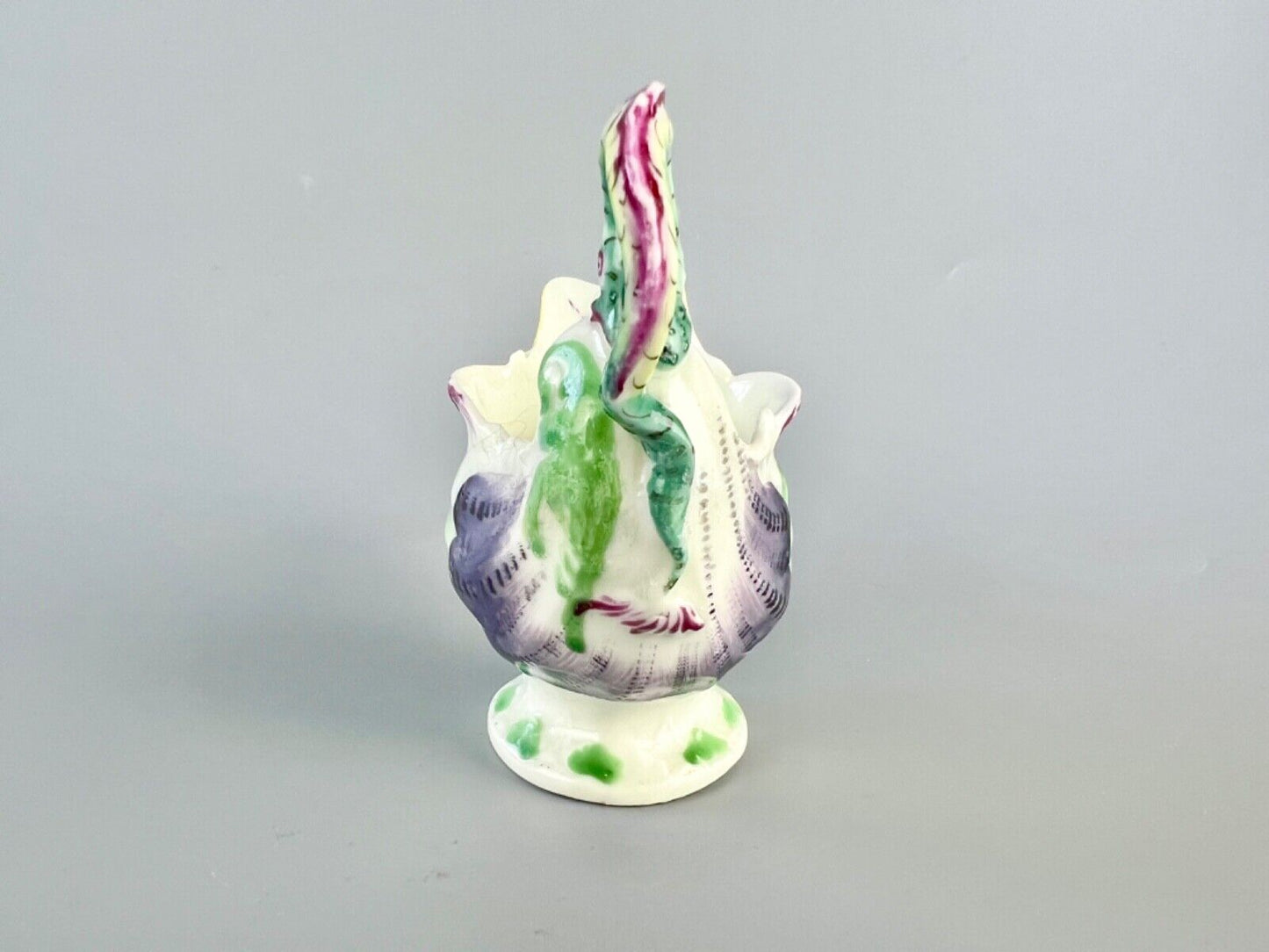A c.1765 Worcester lamprey-handled dolphin-ewer creamer. Polychrome decoration.