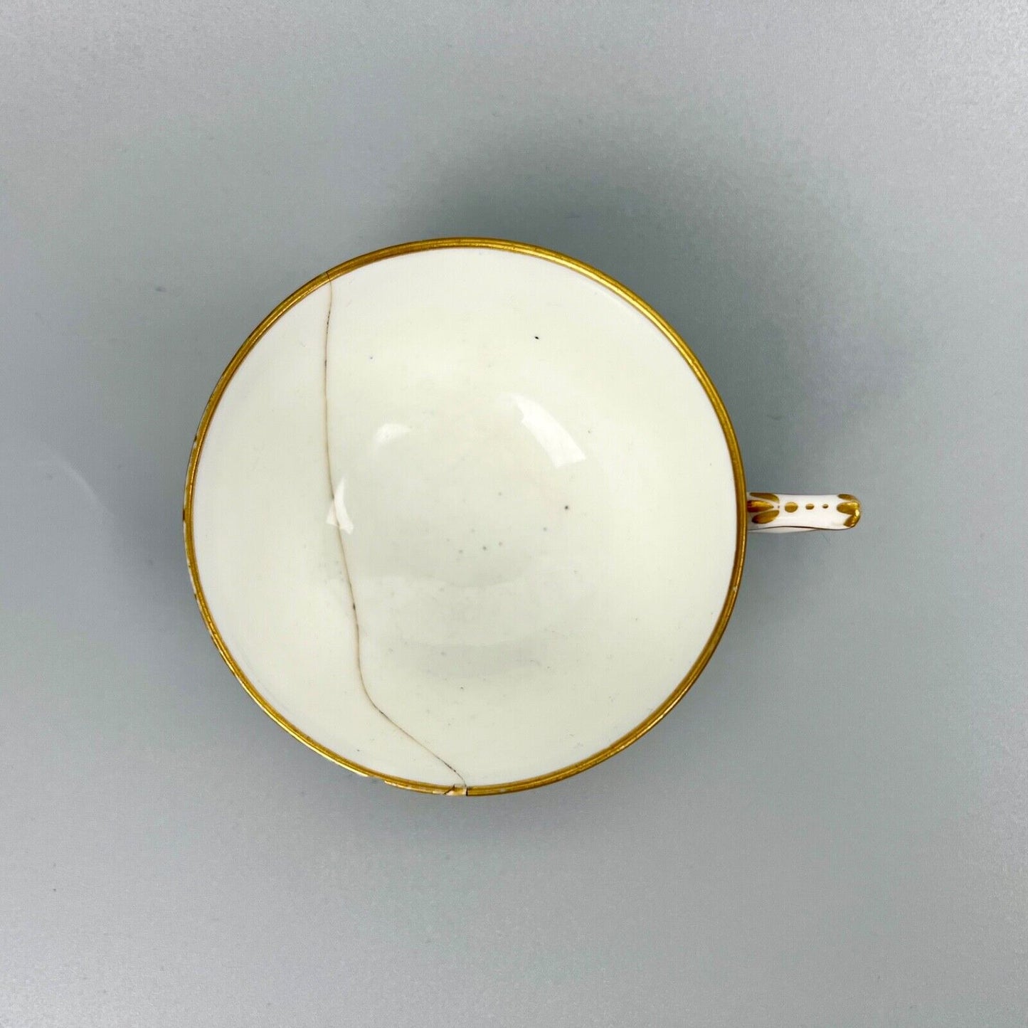 A Sèvres teacup painted by Mde Nouallhier. Date mark mm for 1789. Incised mark