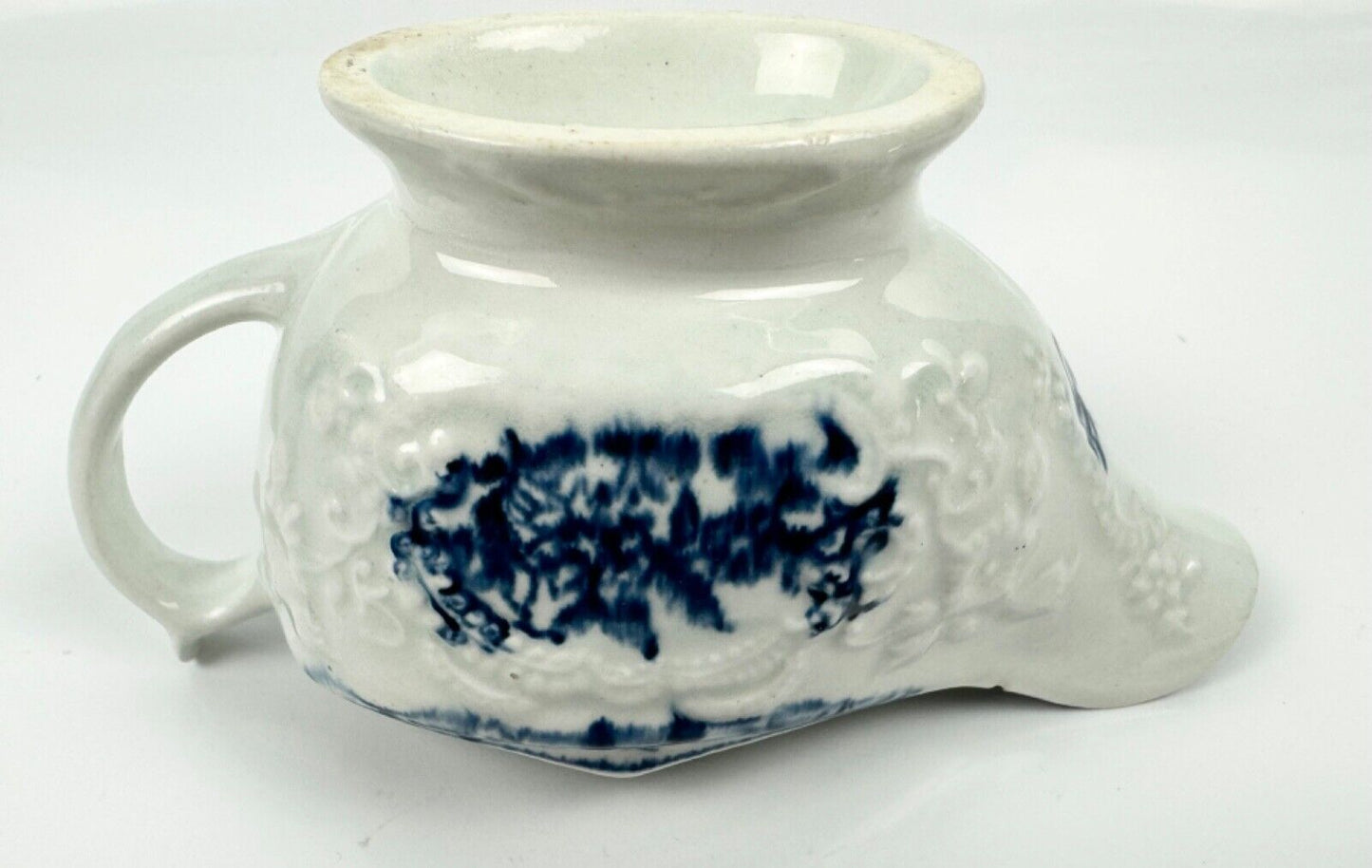 A Lowestoft small sauceboat c1775 with moulded panels and printed decoration.