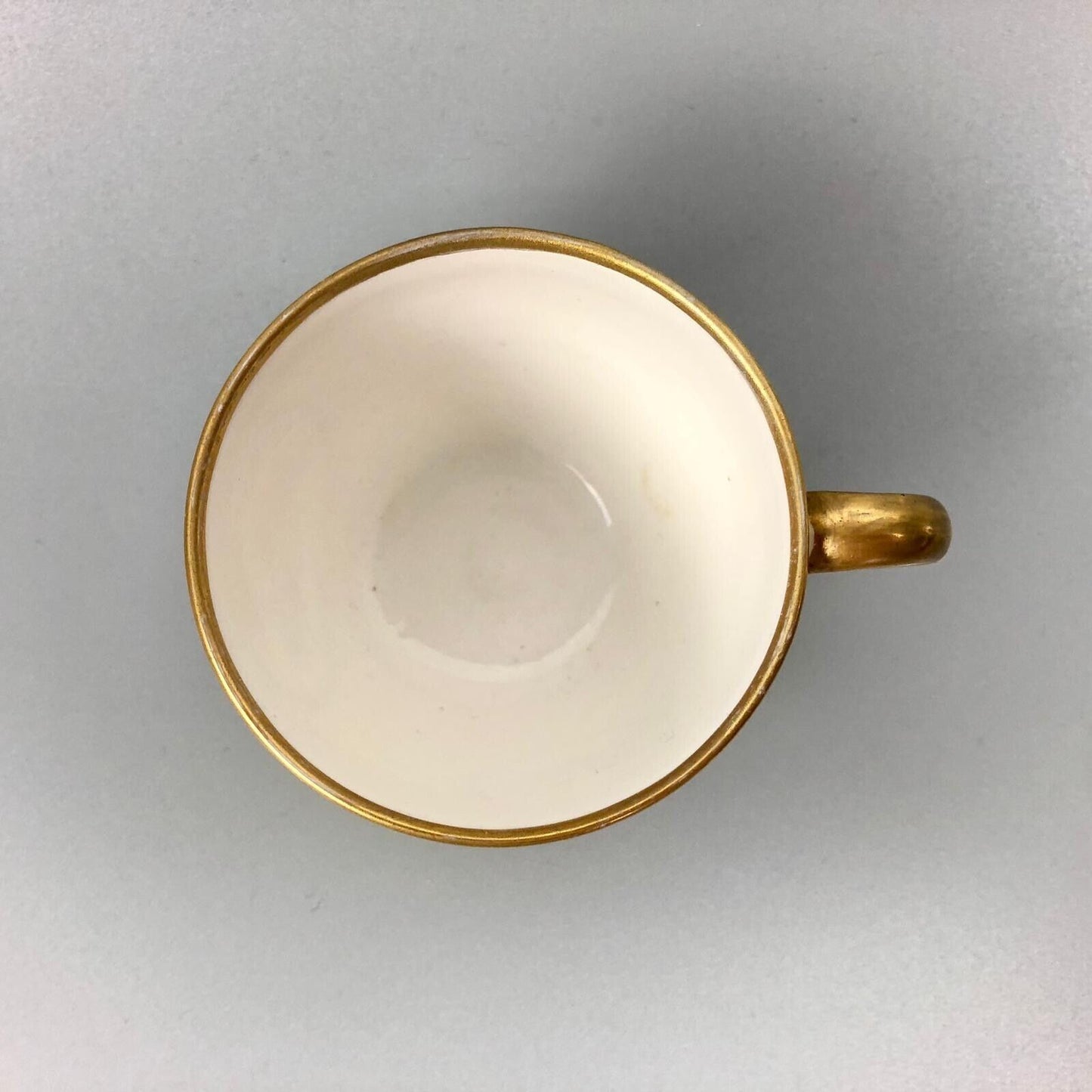A Pinxton coffee cup and saucer in yellow ground and sepia landscapes. C.1796-9