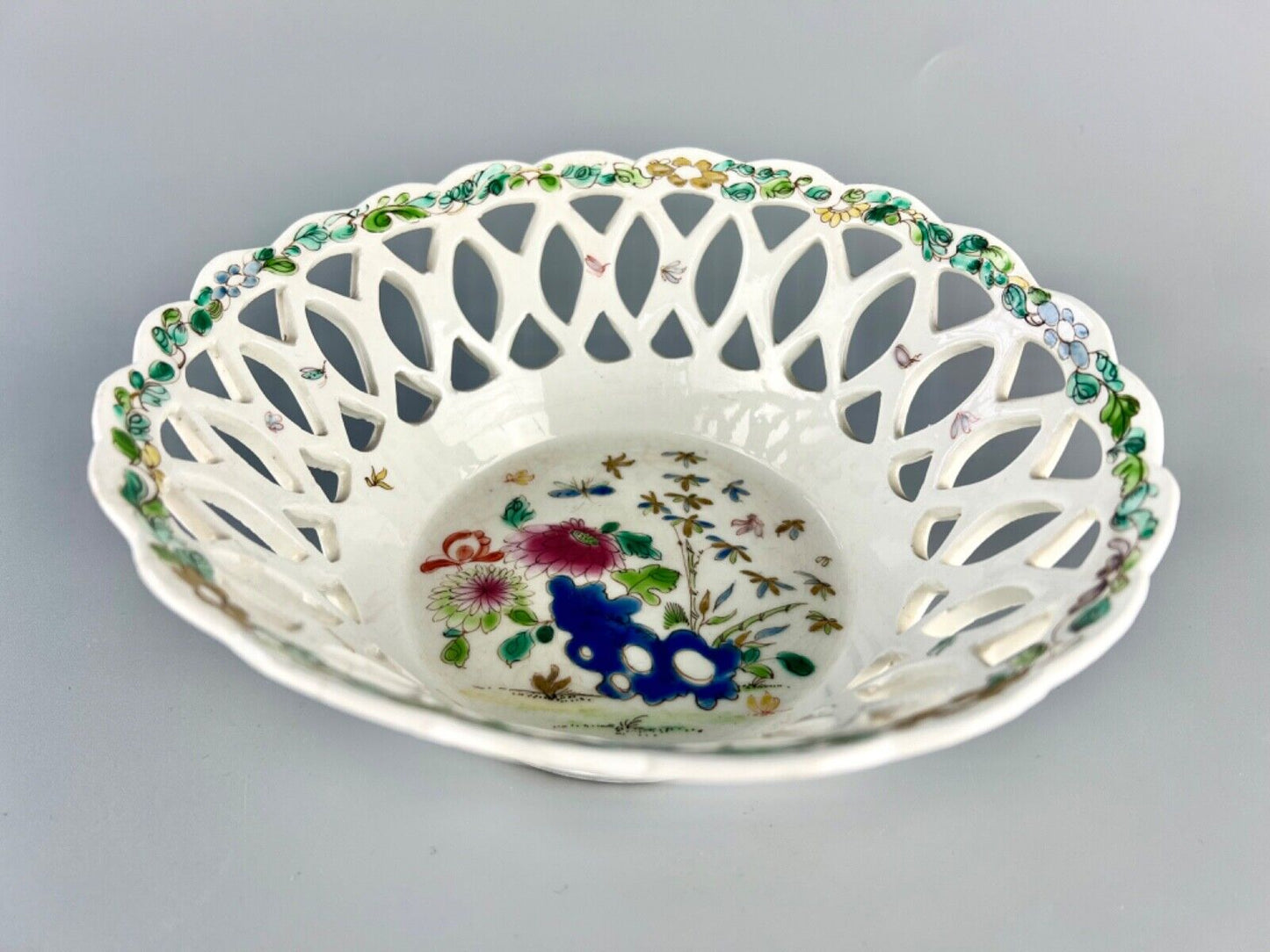 A fine and early Bow porcelain famille rose reticulated basket c.1752