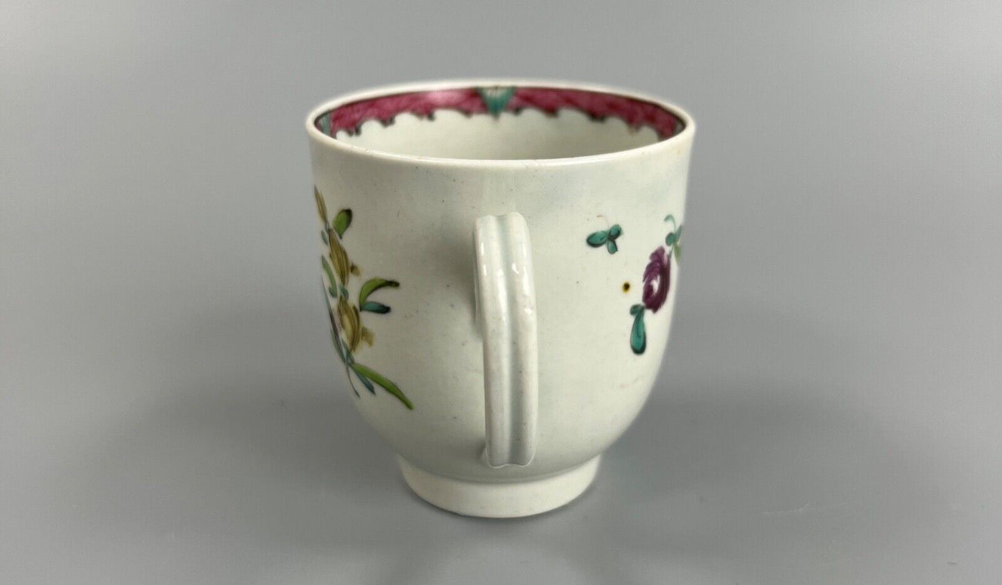 A Seth Pennington Liverpool coffee cup w/painted border & floral decoration