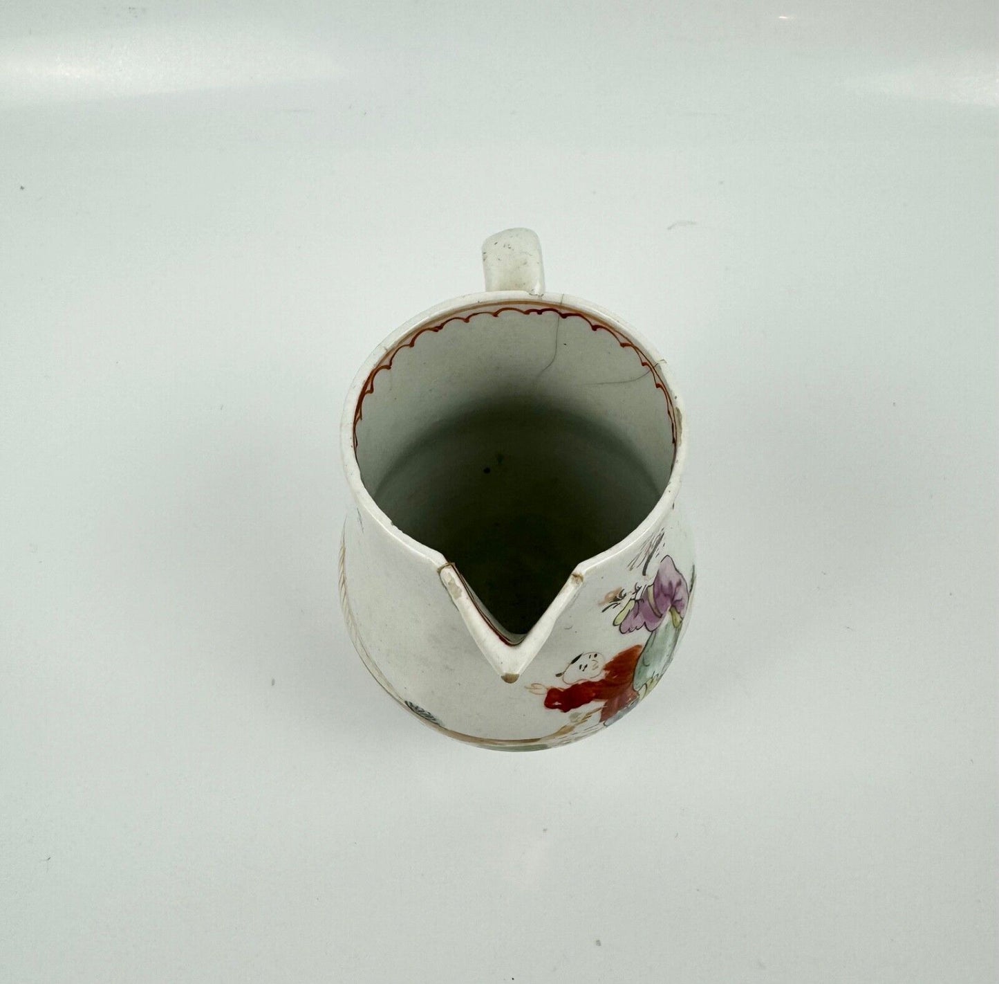 A Lowestoft sparrowbeak creamer c1775 painted with an Oriental figural pattern