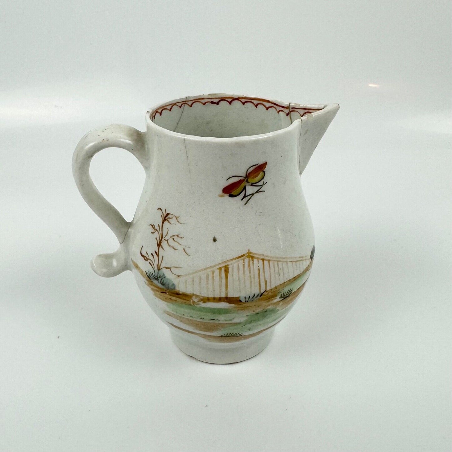 A Lowestoft sparrowbeak creamer c1775 painted with an Oriental figural pattern