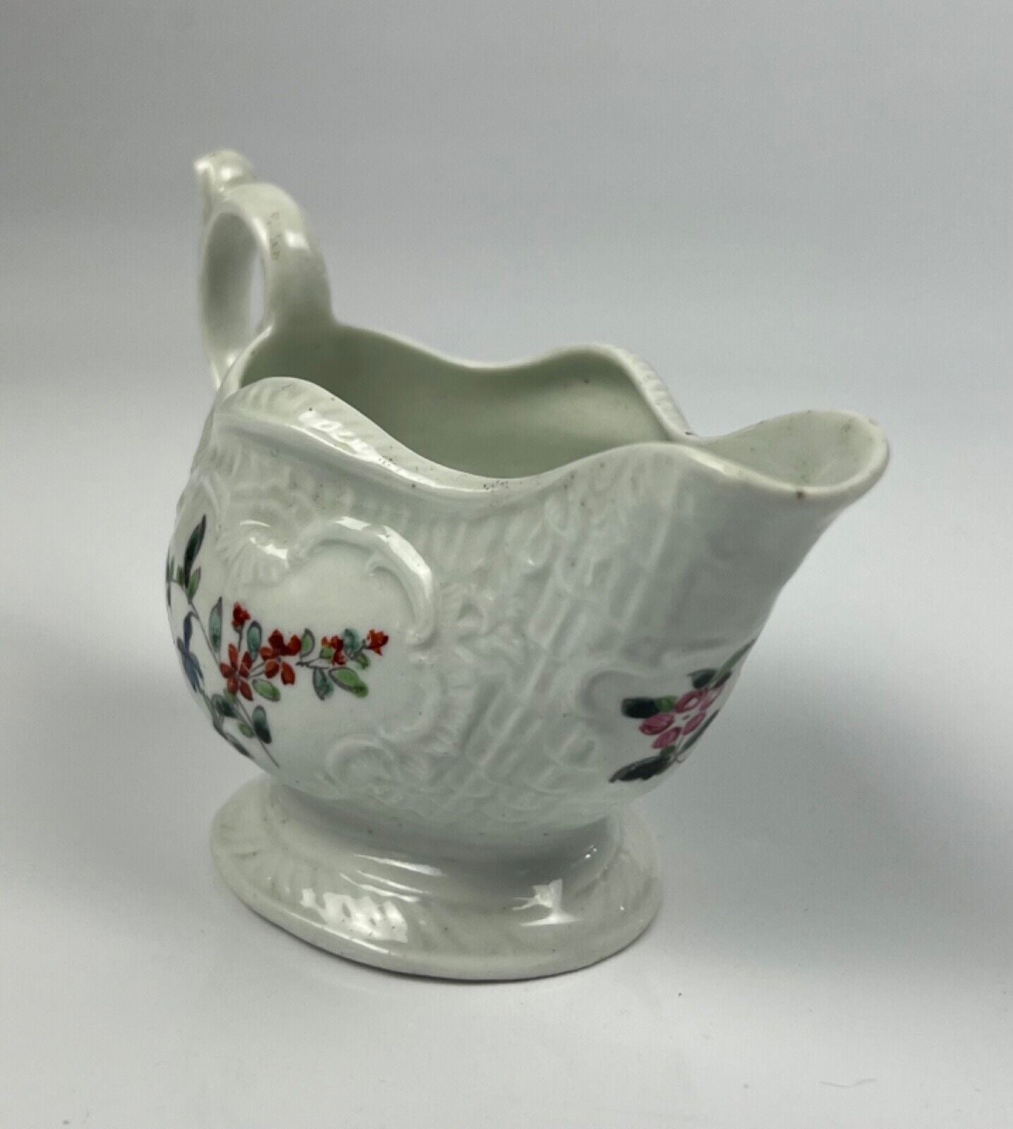 A Philip Christian Liverpool moulded polychrome porcelain sauceboat c.1770