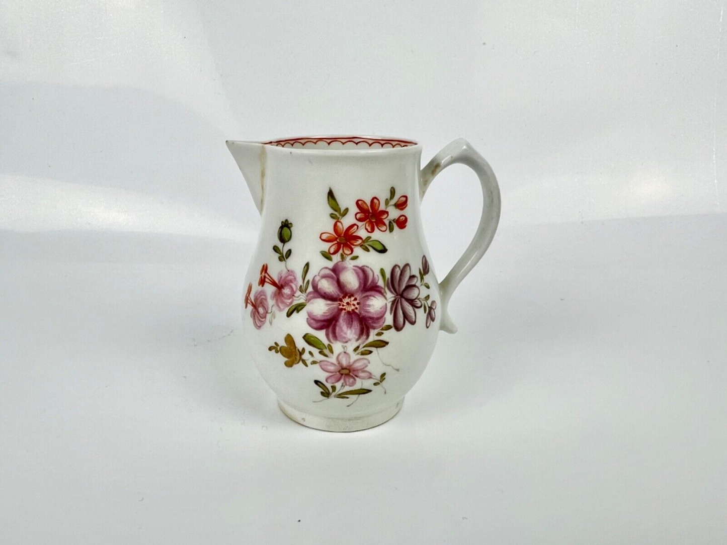 A Lowestoft 'Tulip Painter' creamer painted with floral sprays c.1775