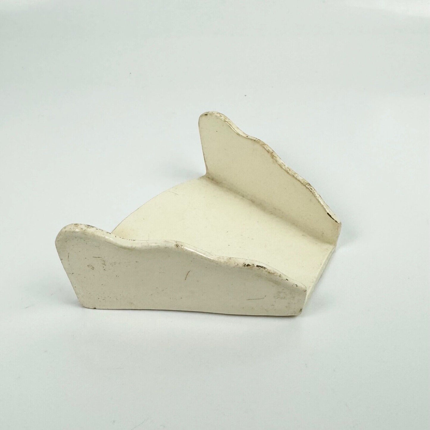 A c.1780-90 creamware asparagus server of trapezoid form with scalloped edges.