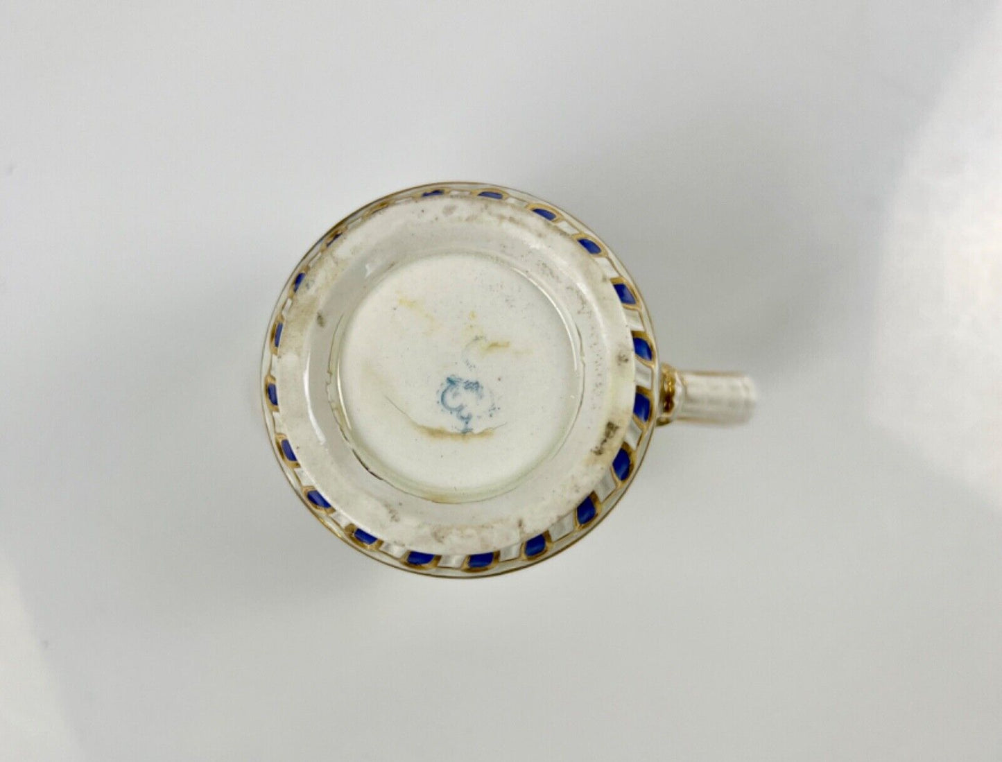 A Chelsea-Derby cabaret creamer of empire shape painted with mask heads c.1770