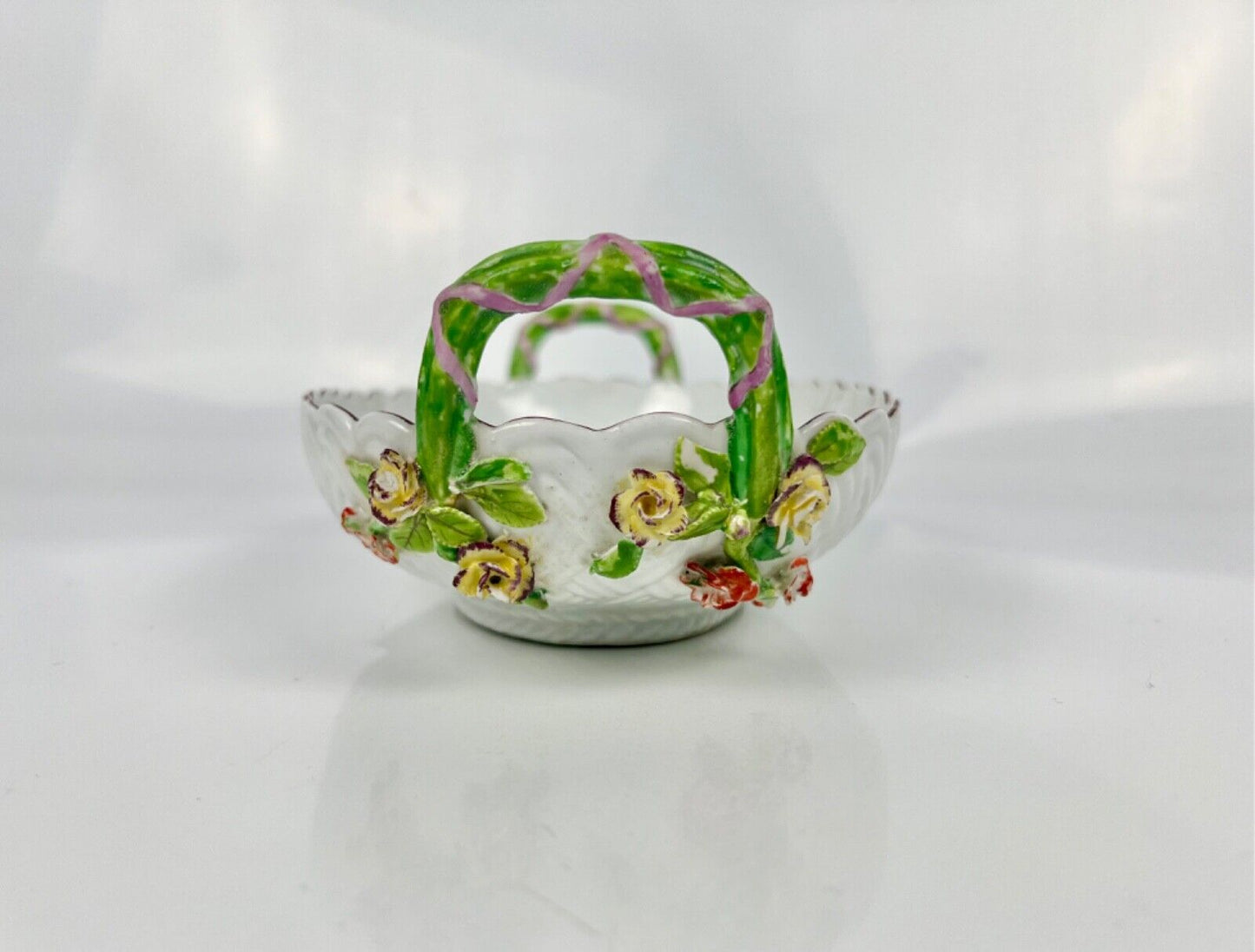 A good Chelsea basketweave moulded basket painted with bouquets. Rustic handles