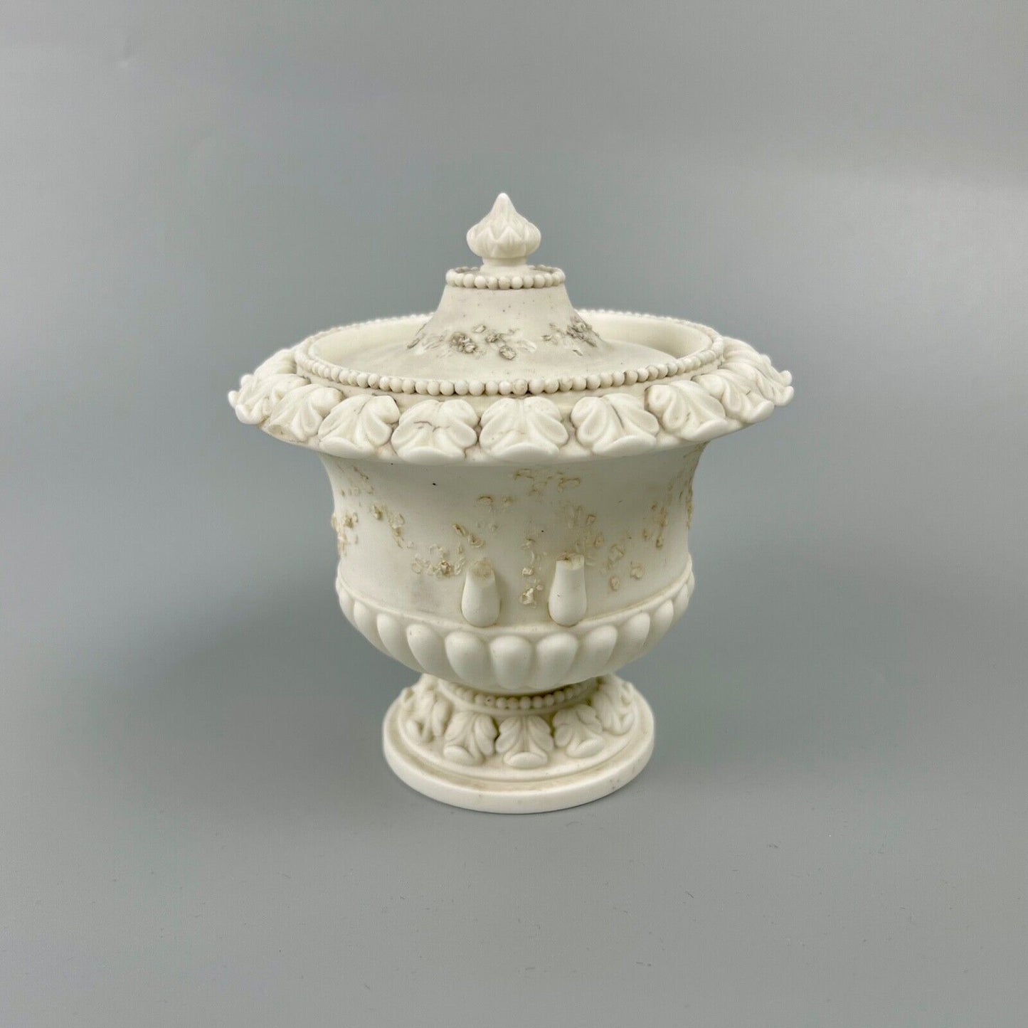 A rare Swansea biscuit lidded urn modelled with flowers and acanthus. c1814-17