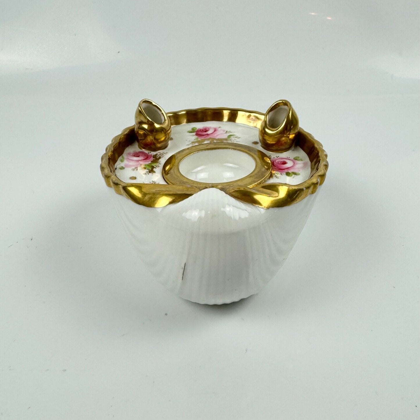 A fine shell-shaped Swansea inkwell and liner painted with roses c1814-26