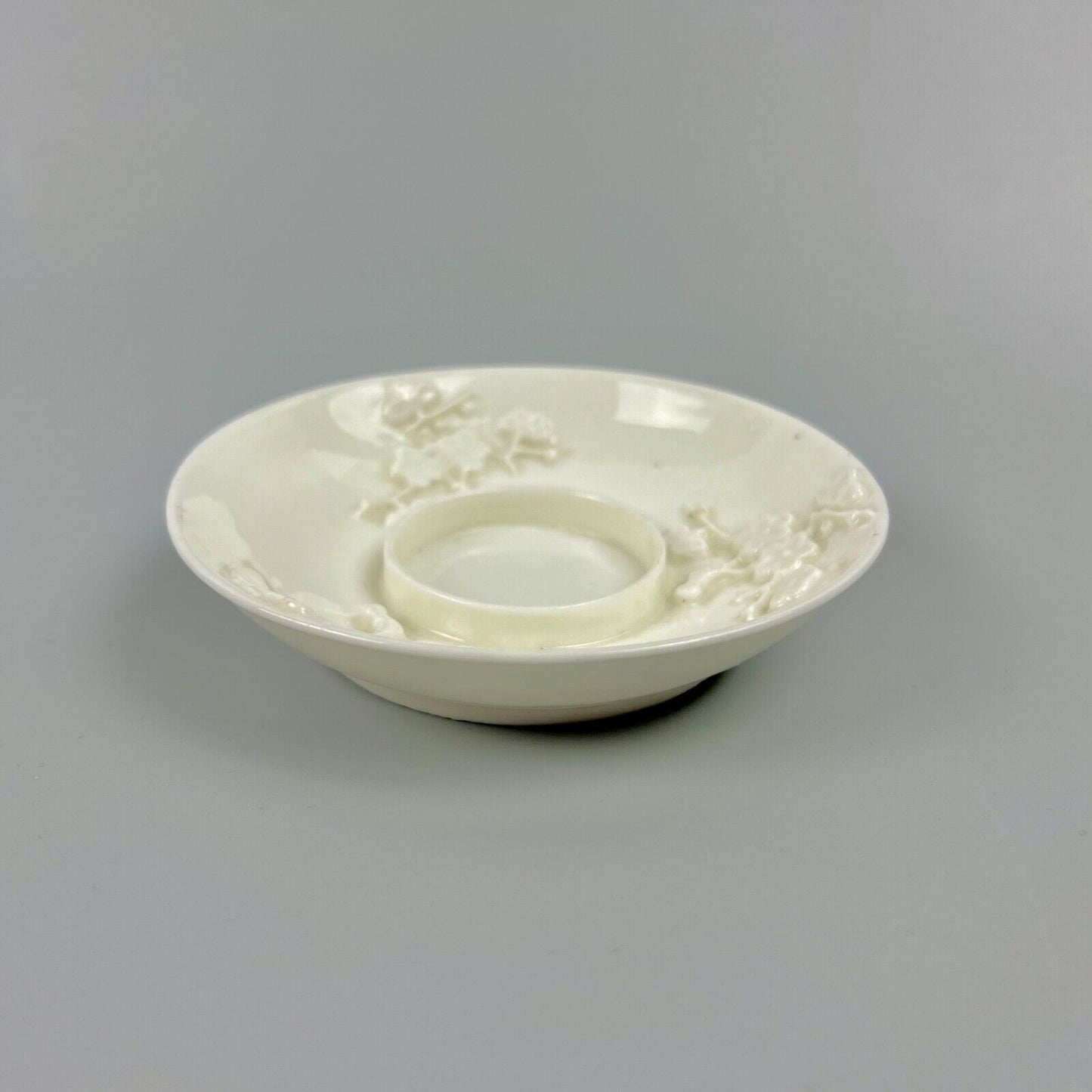 A rare St Cloud trembleuse saucer with prunus relief-moulding c.1735