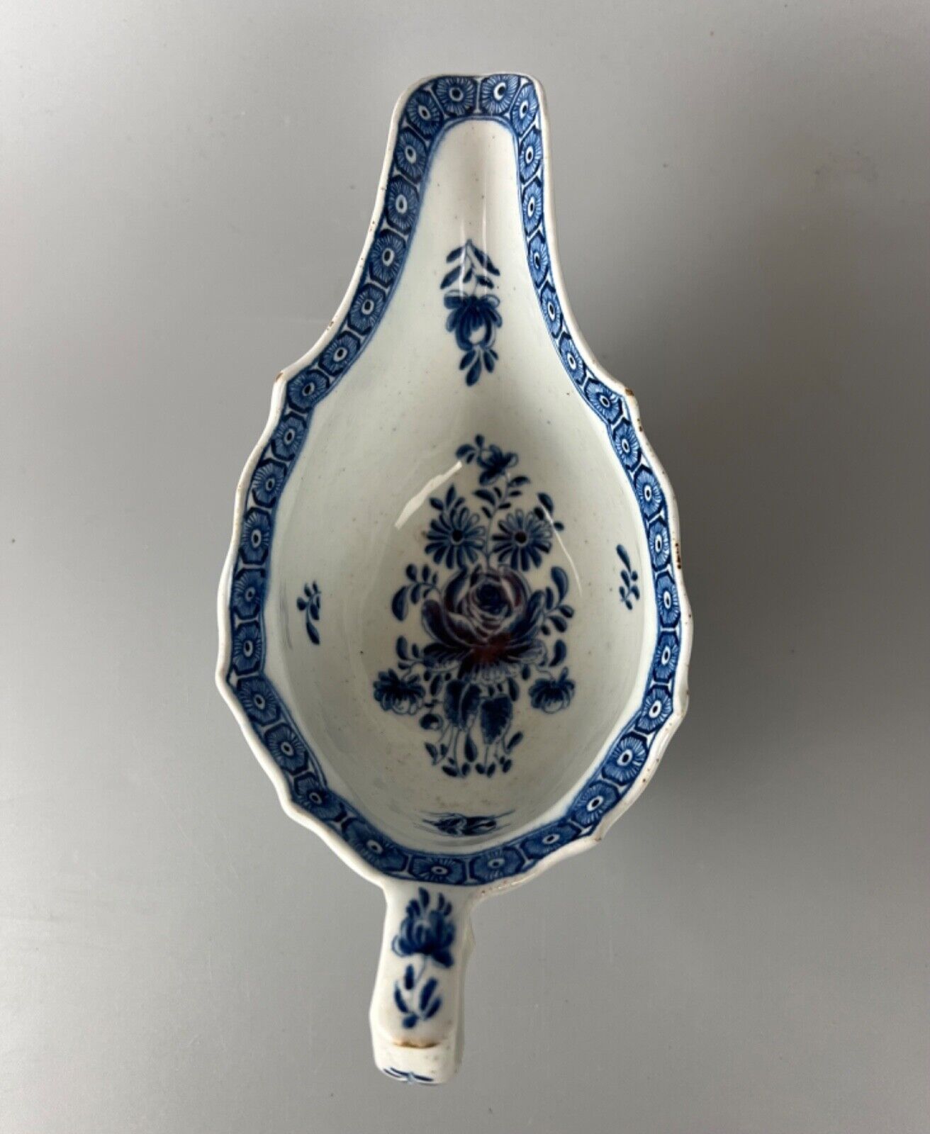 A mid 18thc Bow moulded sauceboat painted in underglaze blue c1765-70