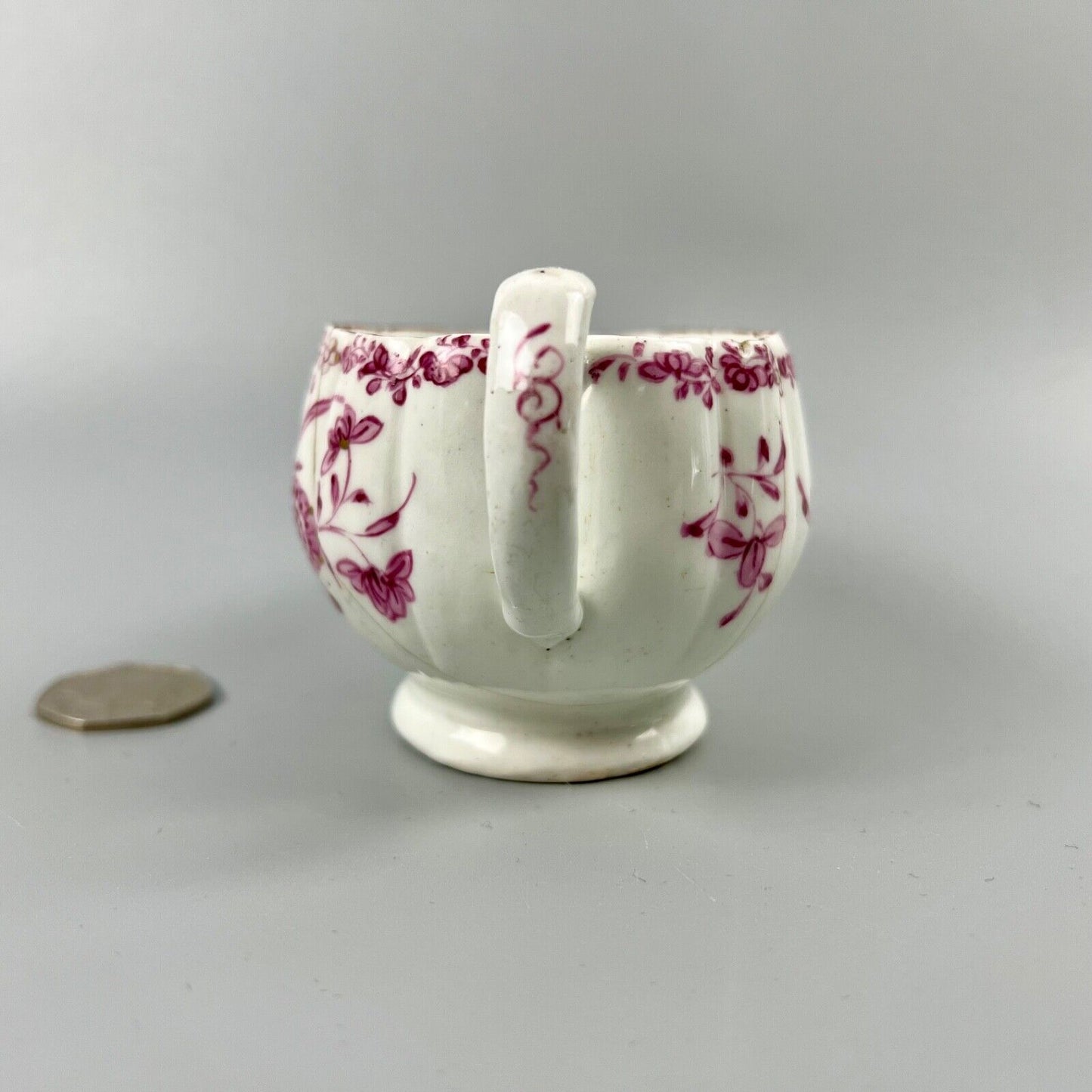 A rare early Derby peach-shaped creamer in 'Banded Hedge' pattern c.1765