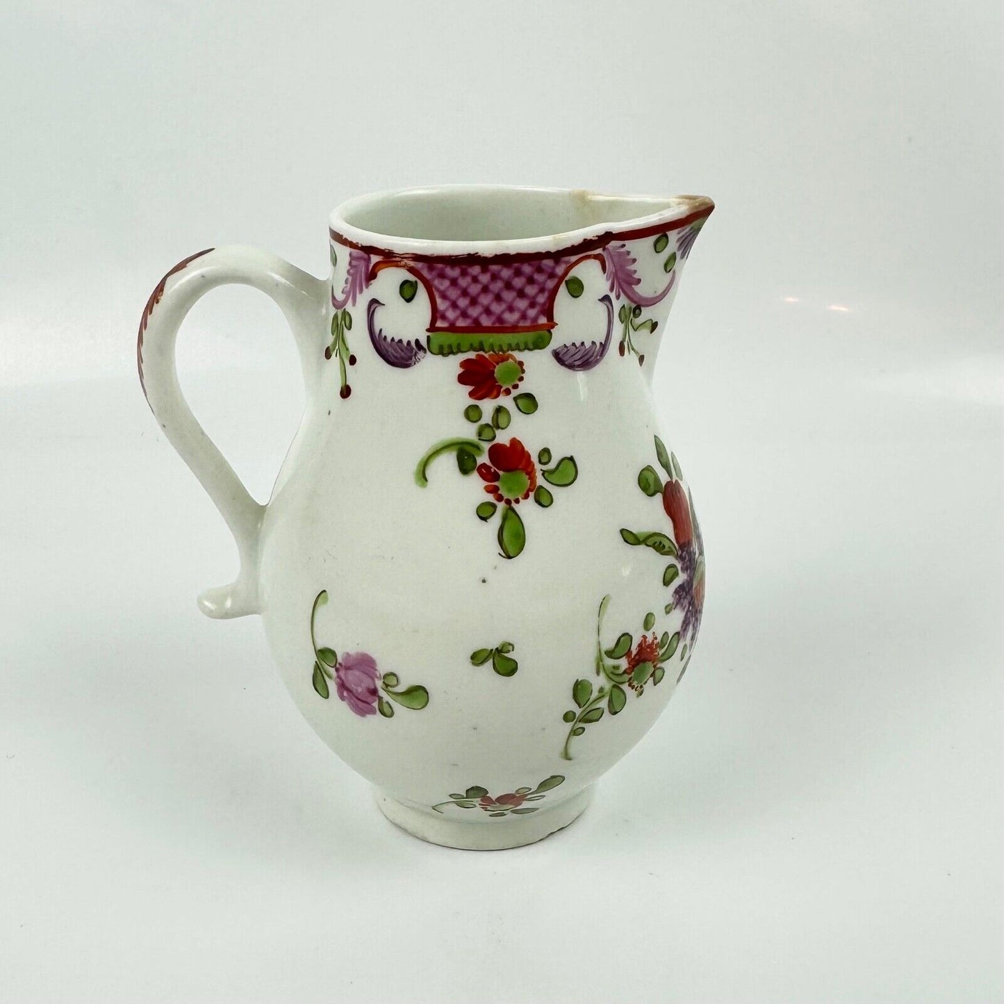 A Lowestoft sparrowbeak creamer c1775 painted with a Curtis style pattern