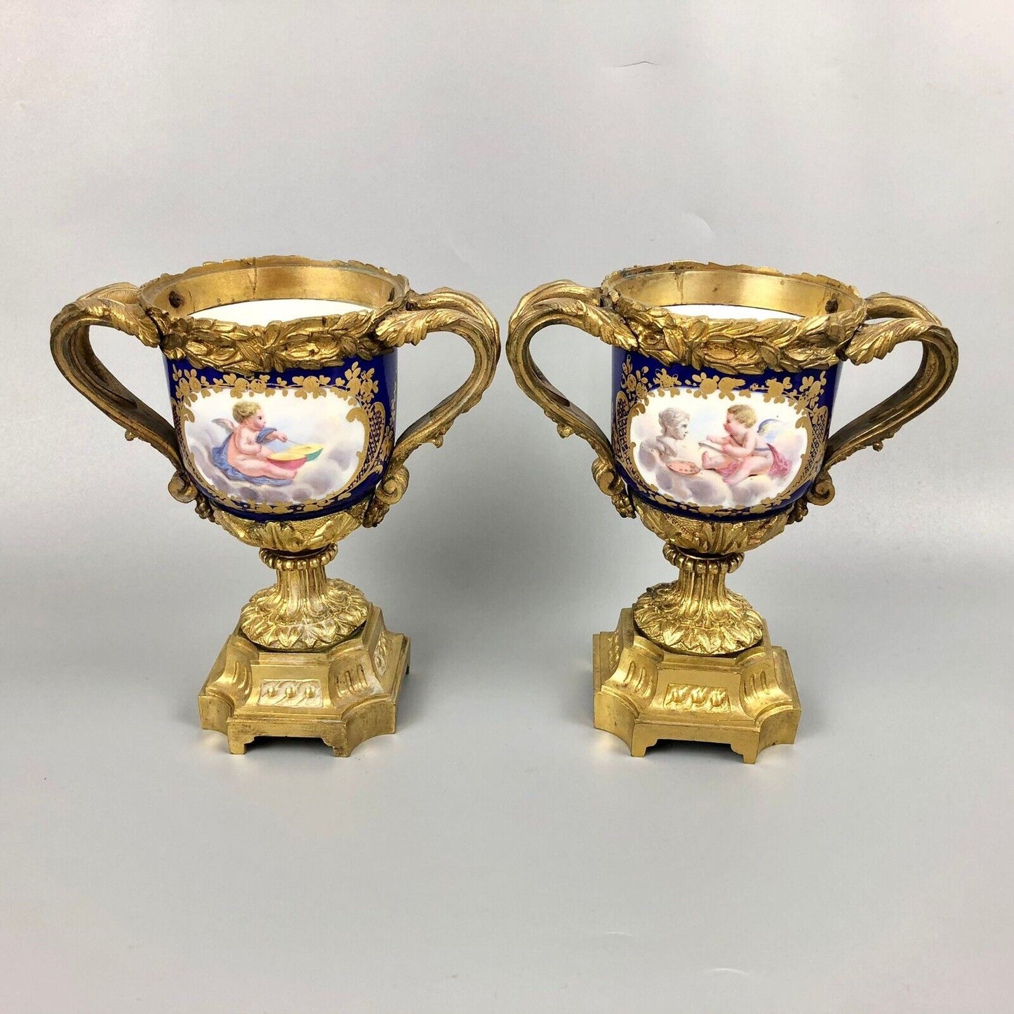 A pair of ormolu Sèvres-style vases painted with exotic birds and putti 1770