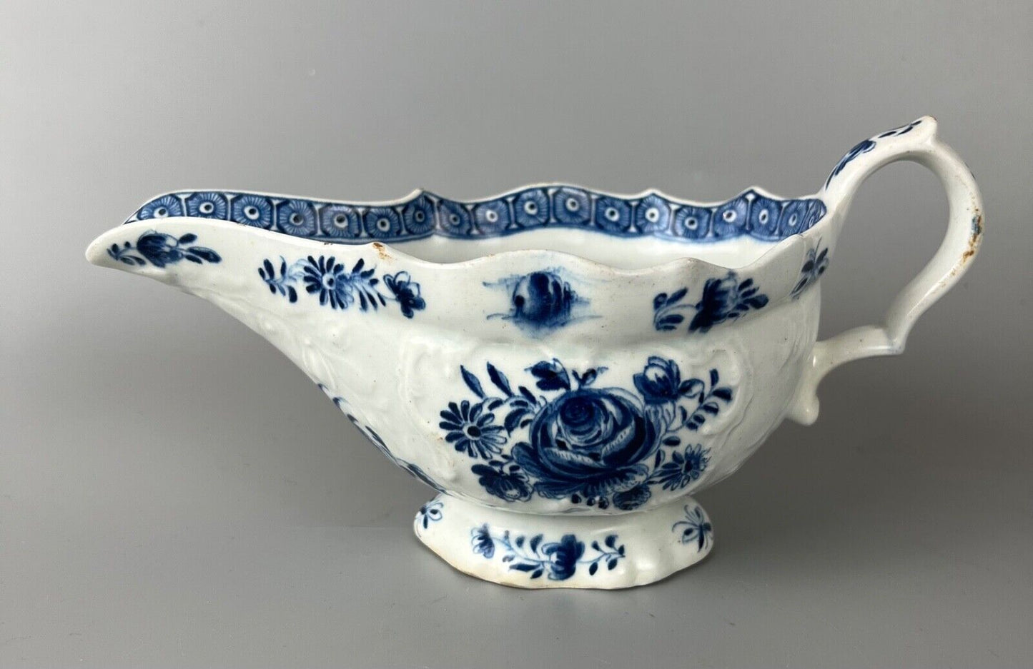 A mid 18thc Bow moulded sauceboat painted in underglaze blue c1765-70