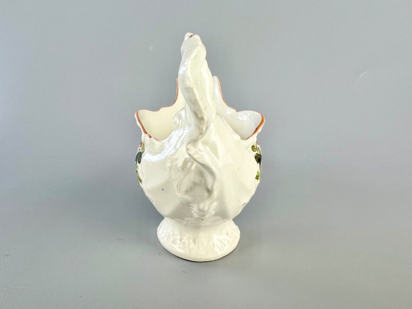 A c.1765 Worcester lamprey-handled dolphin ewer cream jug painted with flowers.