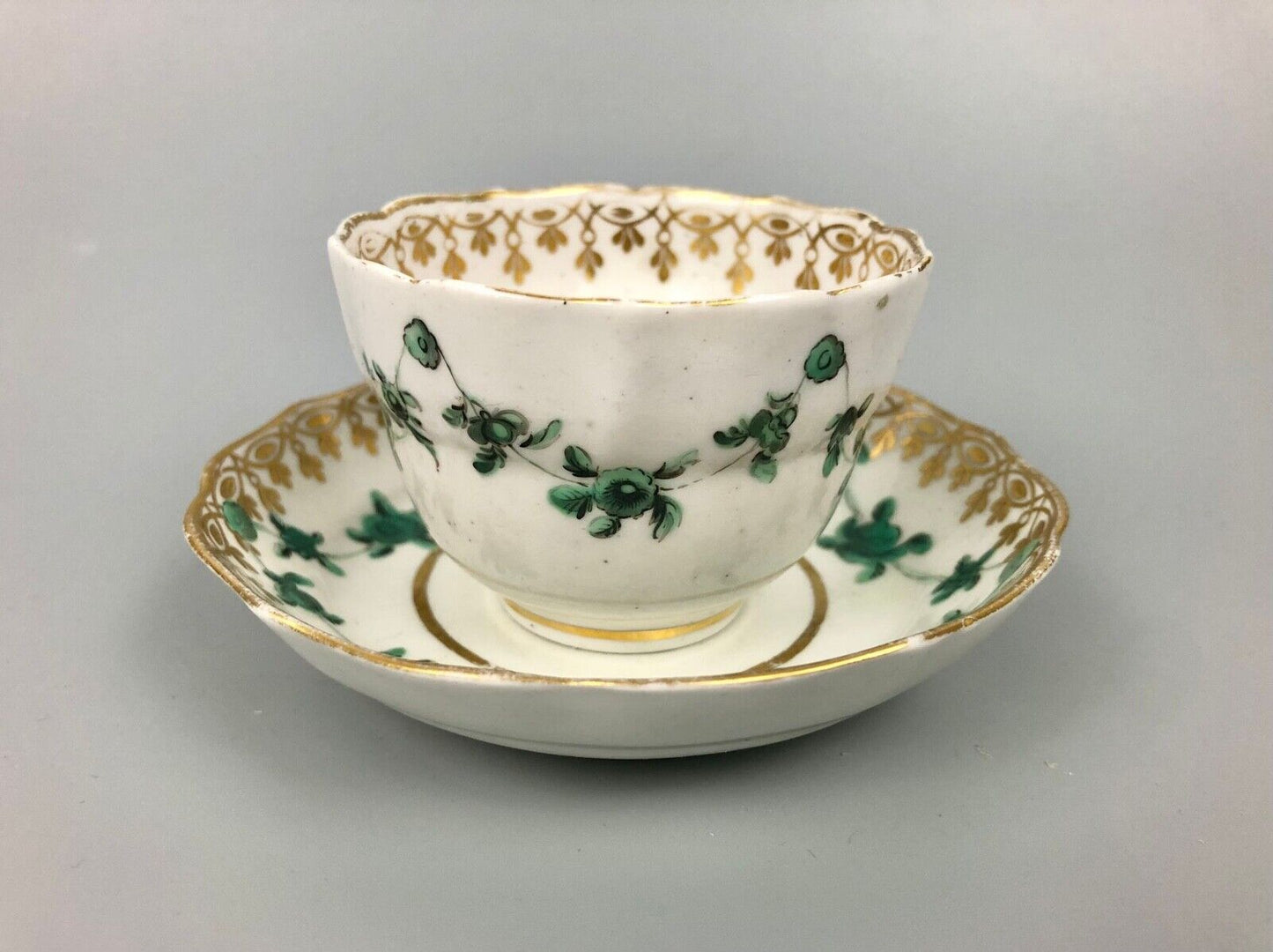 A Derby tea bowl and saucer in the style of Bristol c.1775