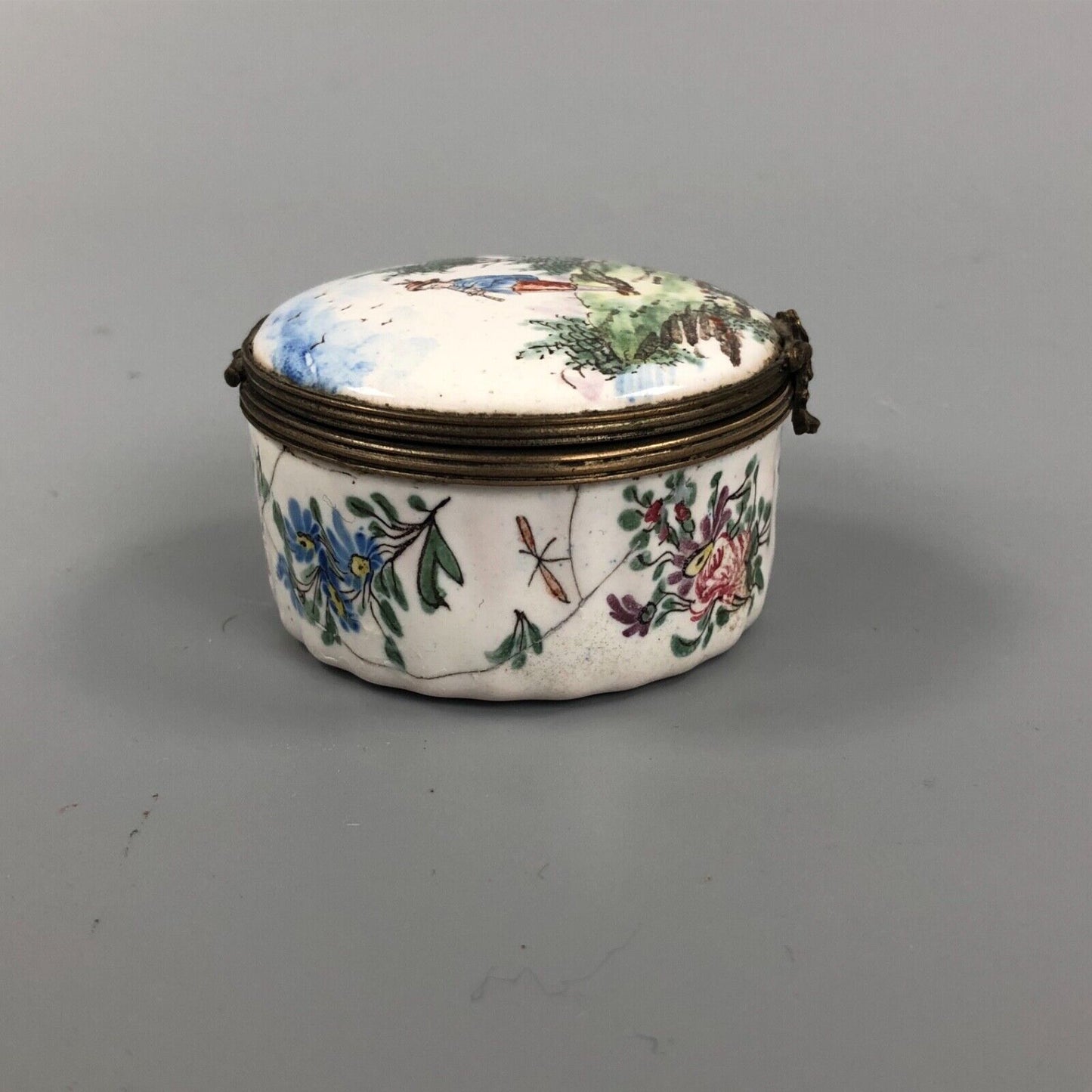An early 19thc. Continental enamel box. Hand Painted with a boy piper.