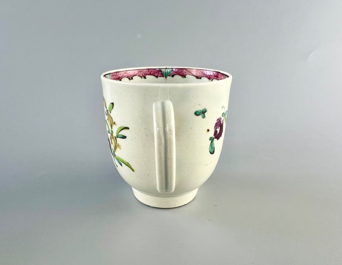 A Worcester polychrome pattern coffee cup with unusual rim decoration c.1770