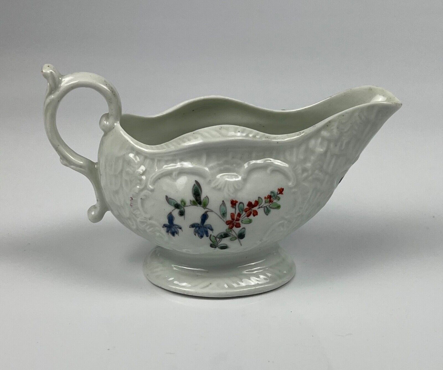 A Philip Christian Liverpool moulded polychrome porcelain sauceboat c.1770