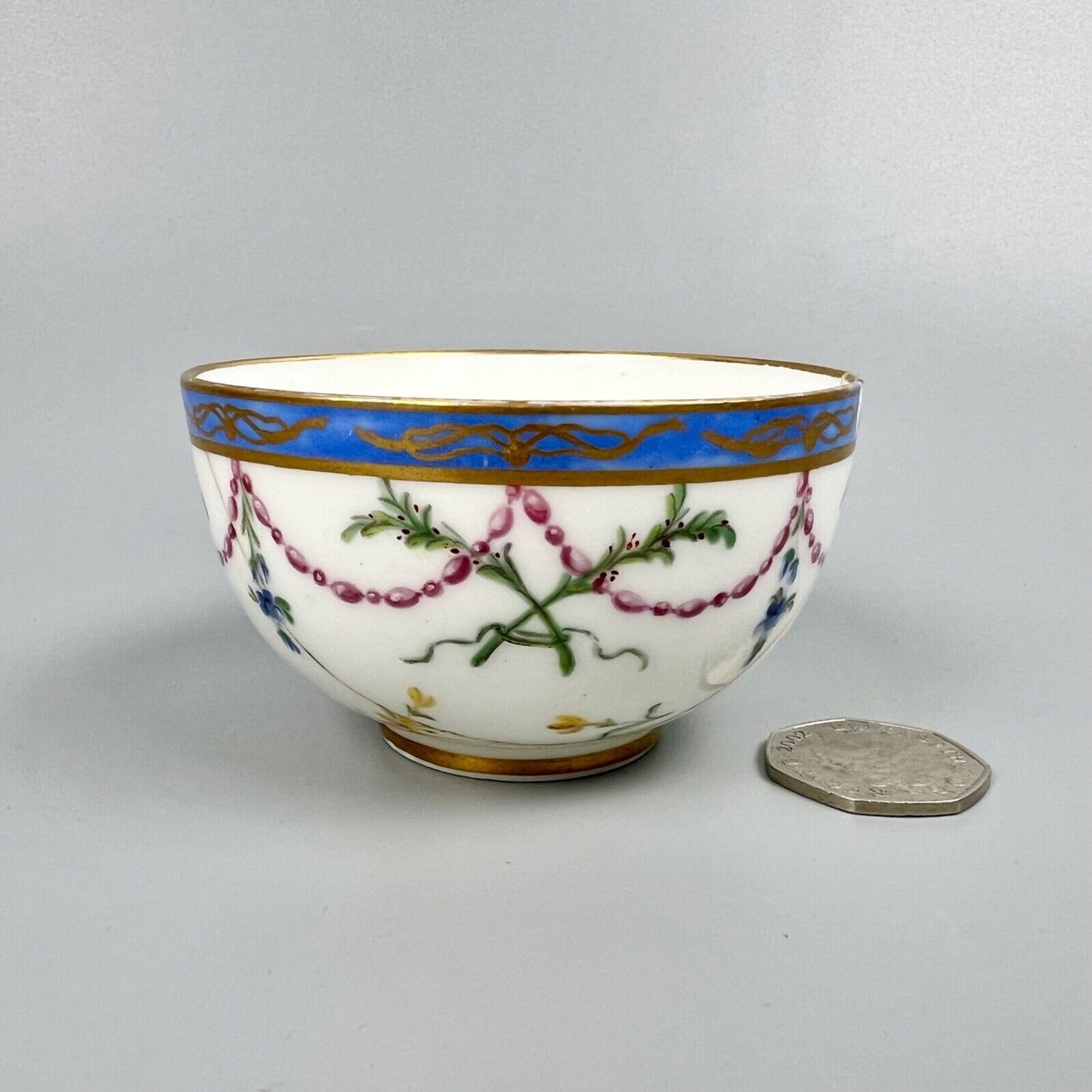 A Sèvres teacup painted by Mde Nouallhier. Date mark mm for 1789. Incised mark