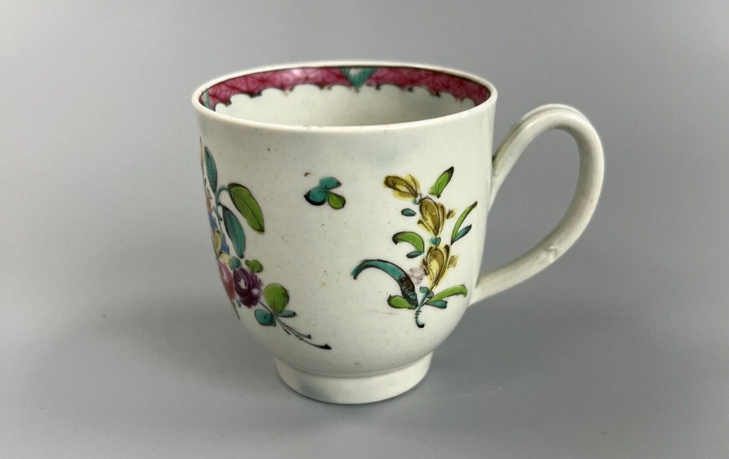 A Seth Pennington Liverpool coffee cup w/painted border & floral decoration