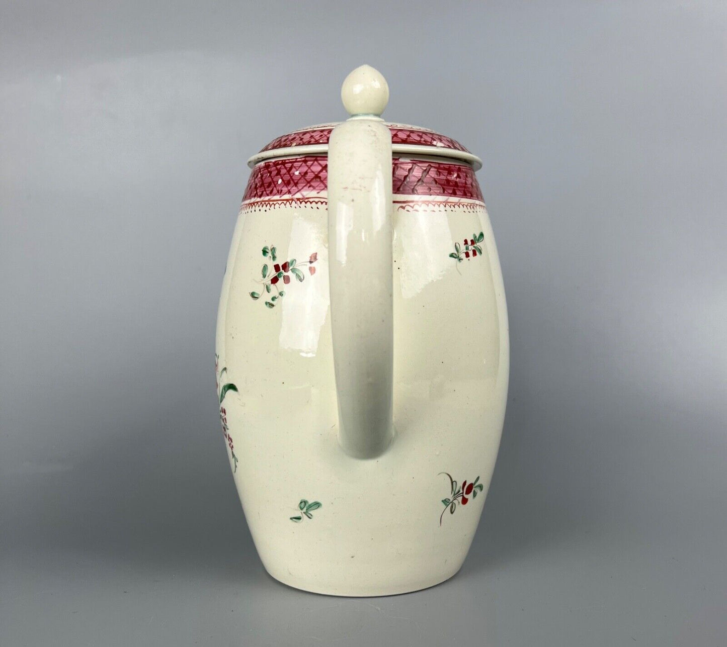 A late 18thc pearlware covered jug. Polychrome floral decoration.