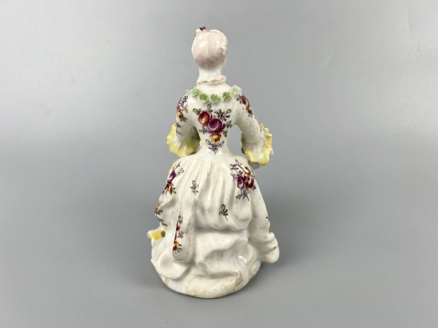 A Derby 'Pale Family' figure of 'Lady Seated Holding a Musical Score'. c1756-9